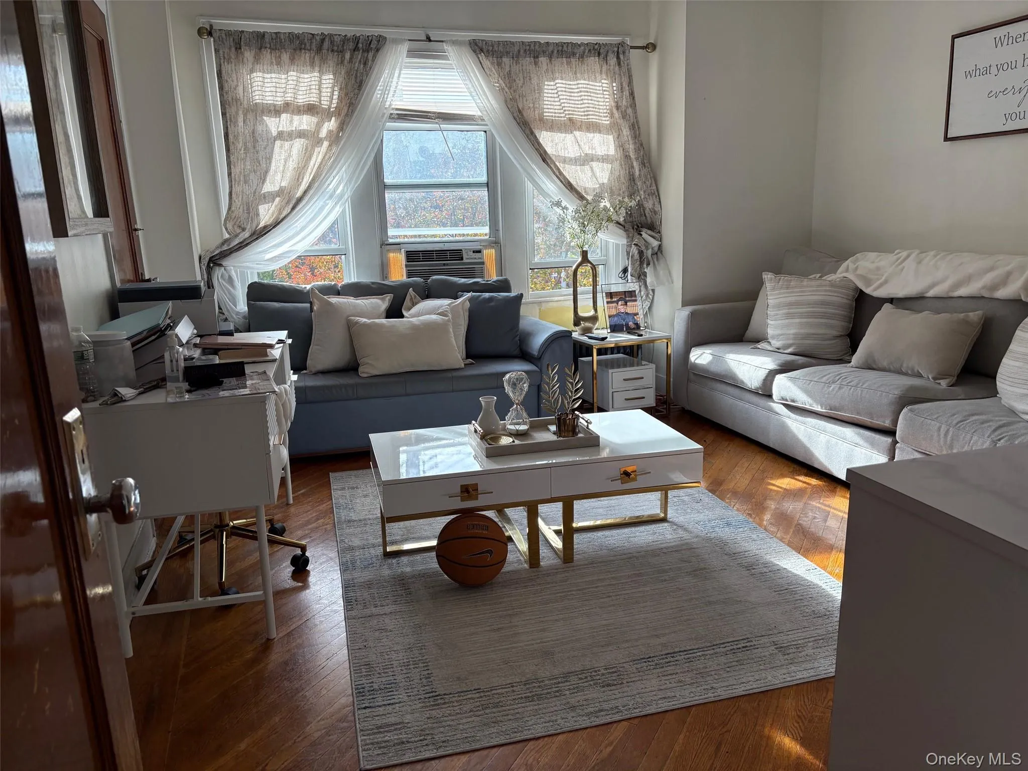 Living room with wood-type flooring and cooling unit Living room with wood-type flooring and cooling unit