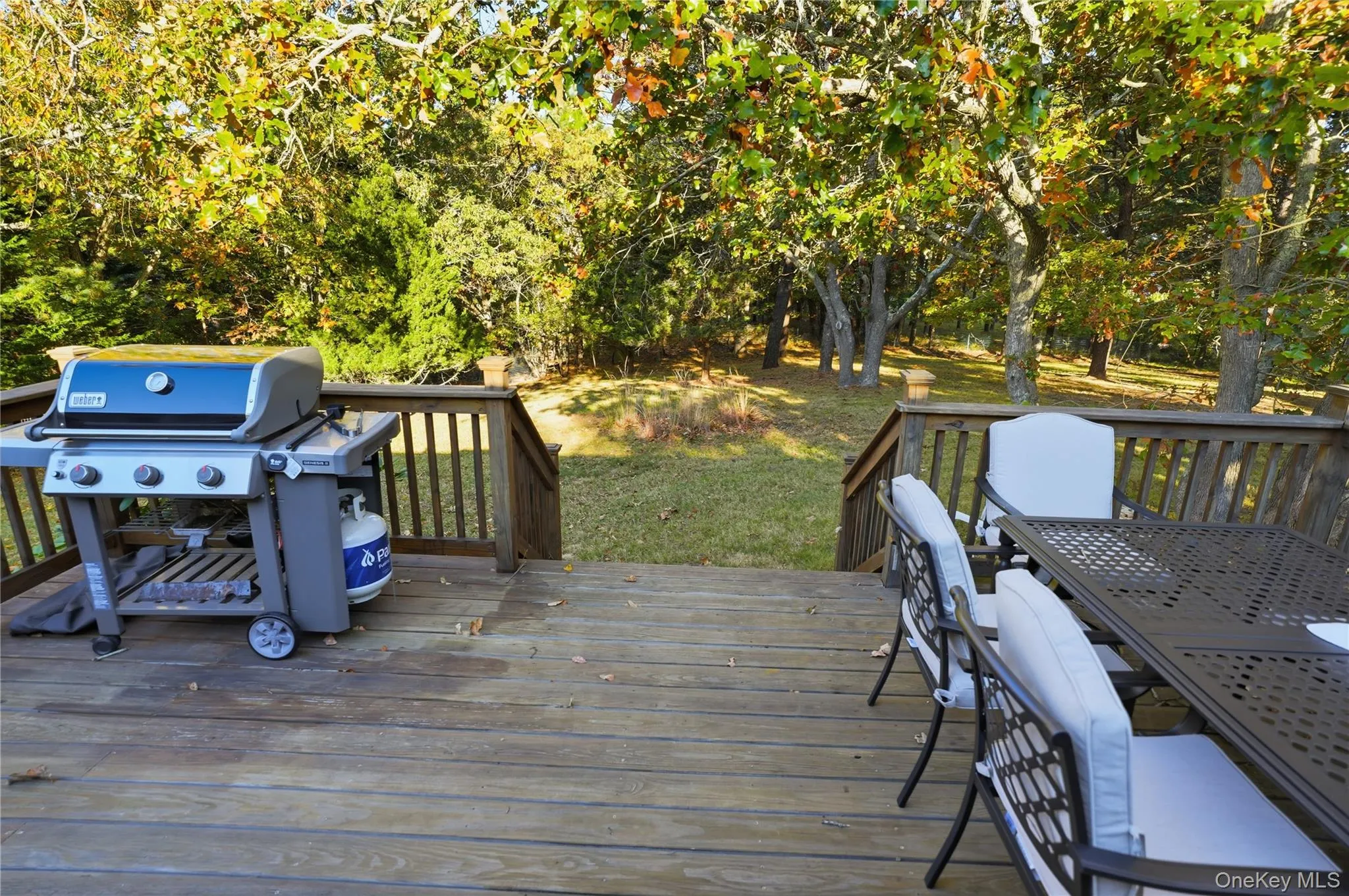 Wooden deck featuring grilling area and outdoor dining area Wooden deck featuring grilling area and outdoor dining area