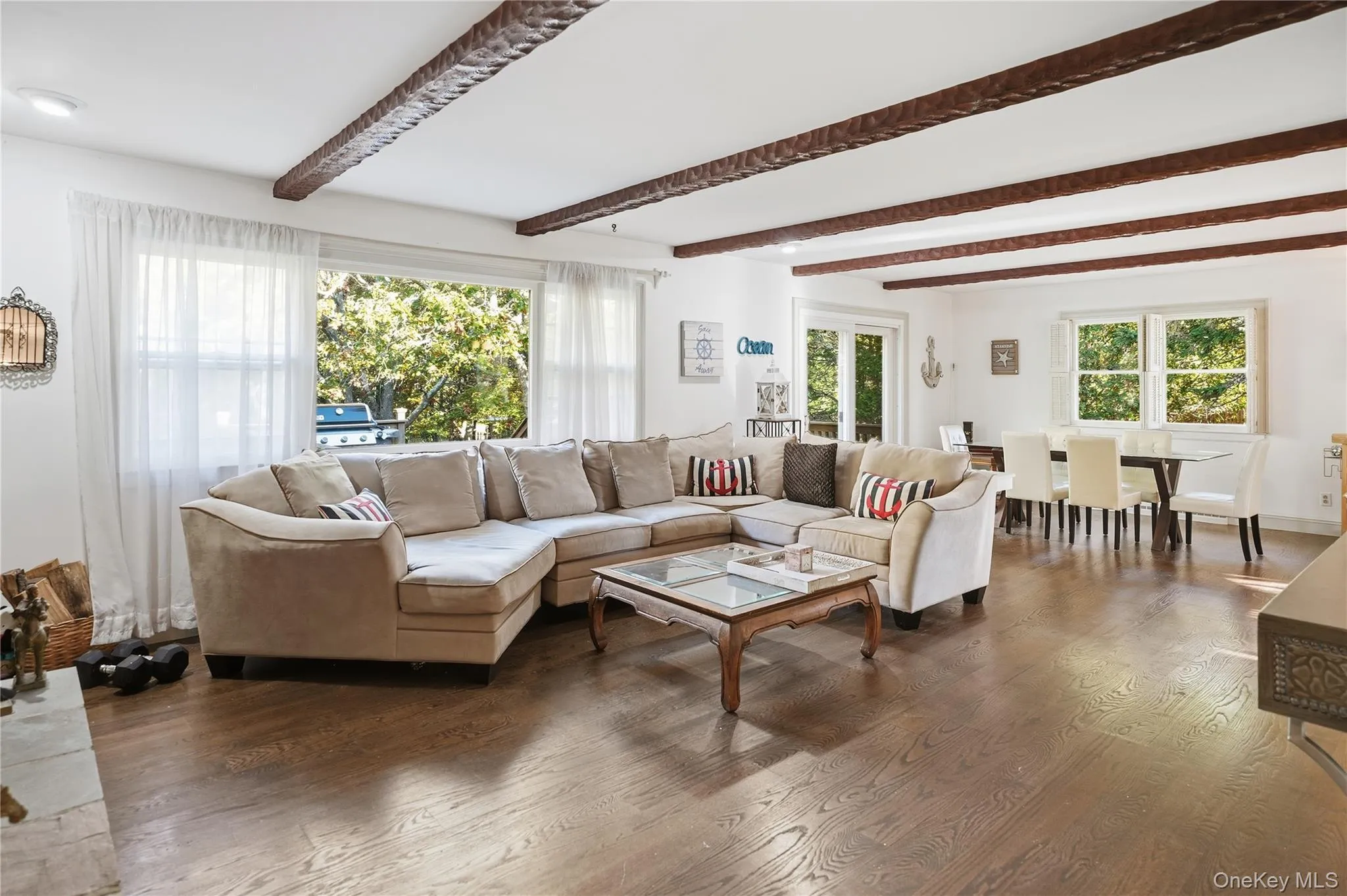 Living room with beamed ceiling and wood finished floors Living room with beamed ceiling and wood finished floors