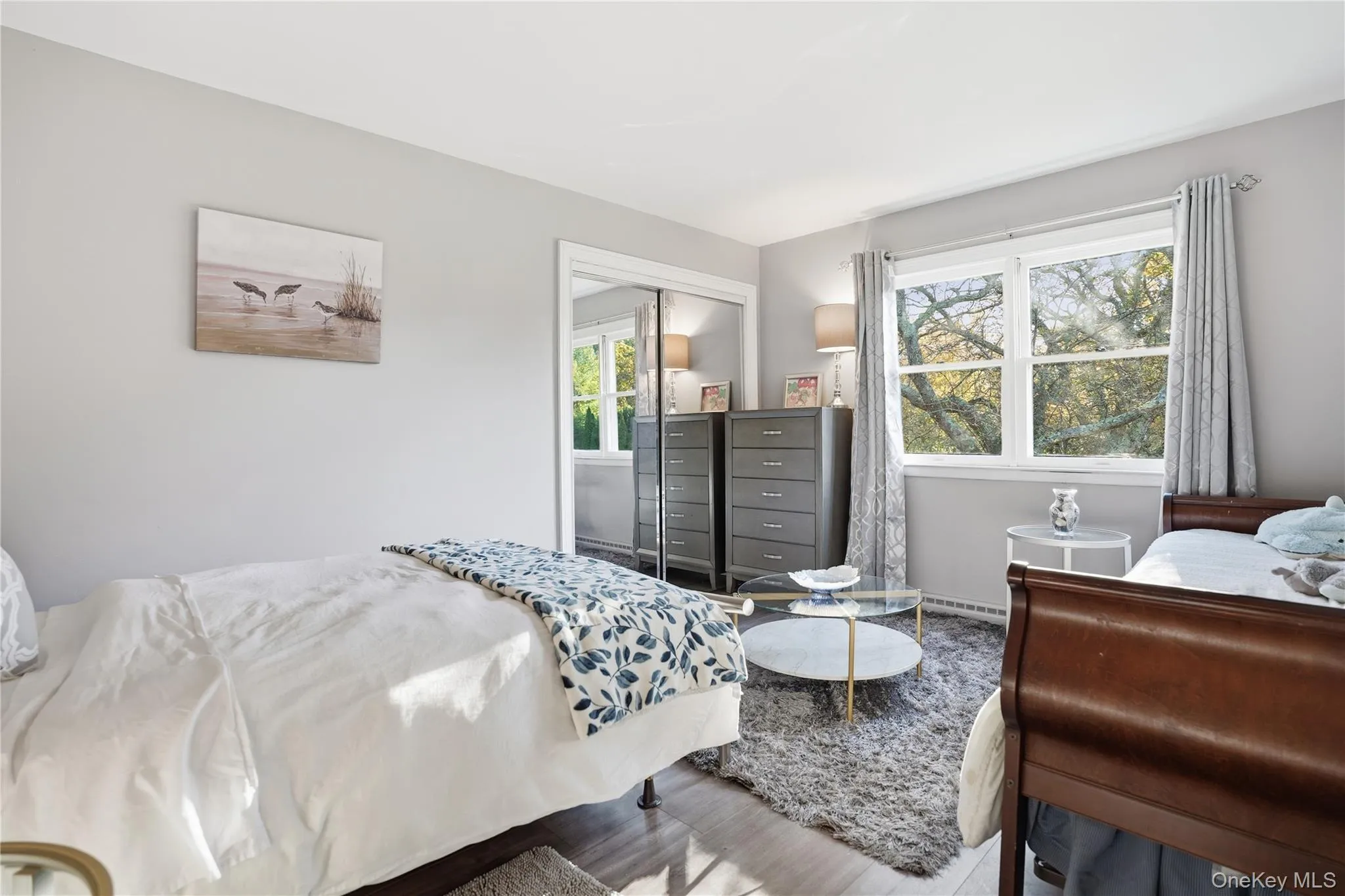 Bedroom with wood finished floors and a closet Bedroom with wood finished floors and a closet