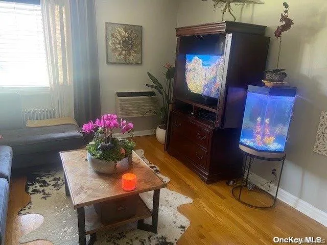 Living area with baseboards and light wood-style floors Living area with baseboards and light wood-style floors