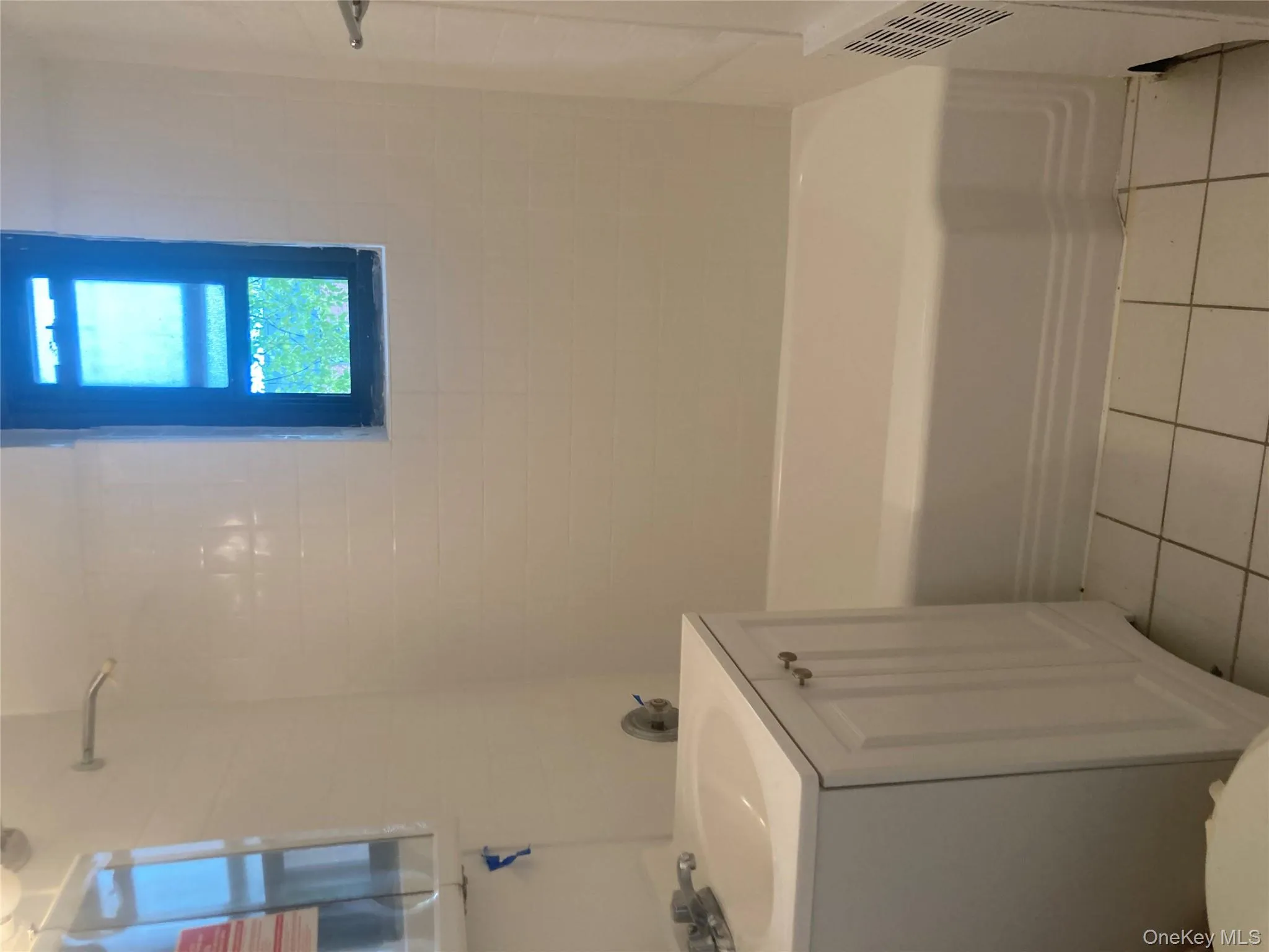 Windowed Bathroom with vanity, light tile flooring, shower / tub combination Windowed Bathroom with vanity, light tile flooring, shower / tub combination