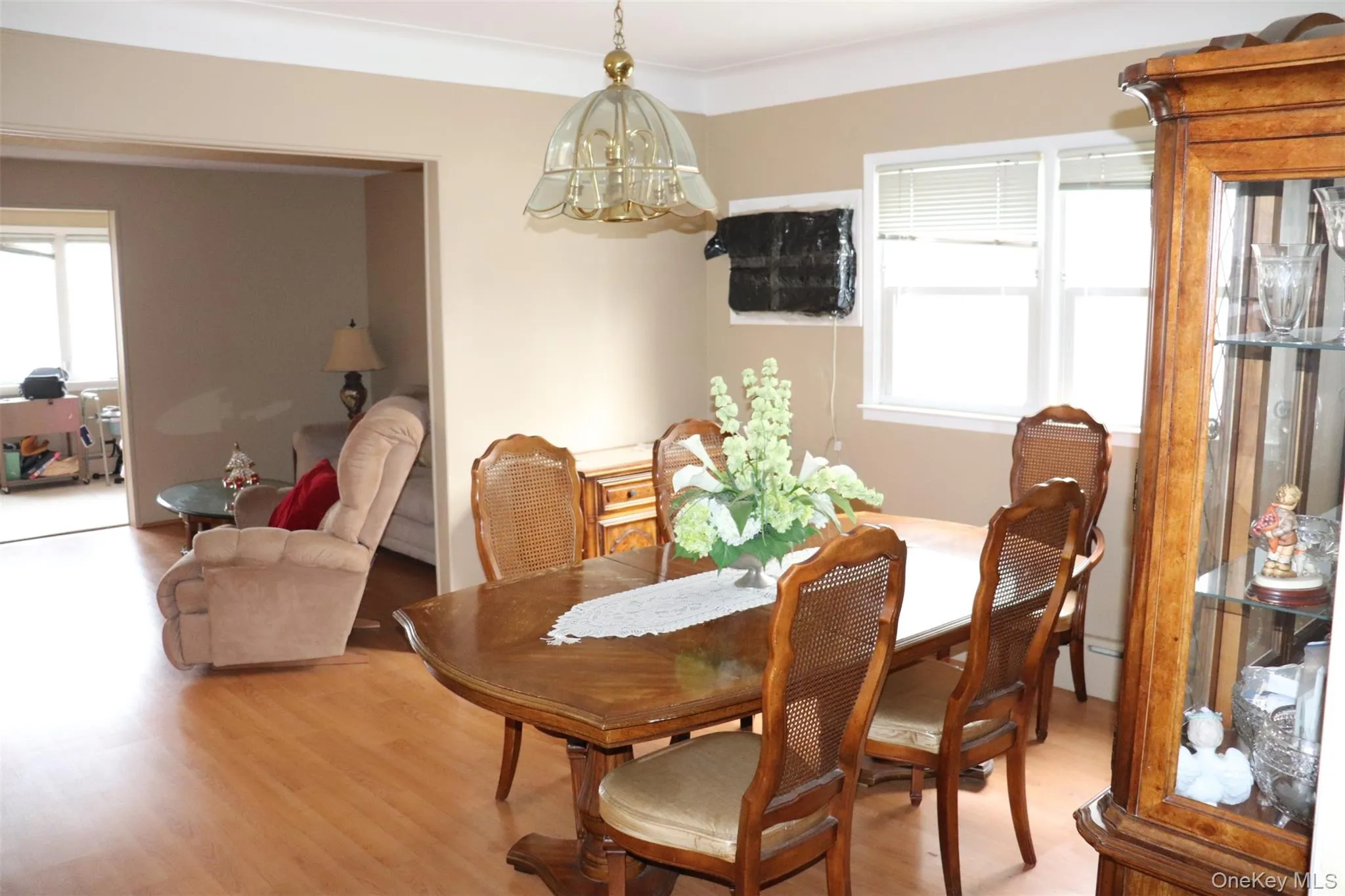 Dining area featuring light wood finished floors, a chandelier, and a baseboard heating unit Dining area featuring light wood finished floors, a chandelier, and a baseboard heating unit
