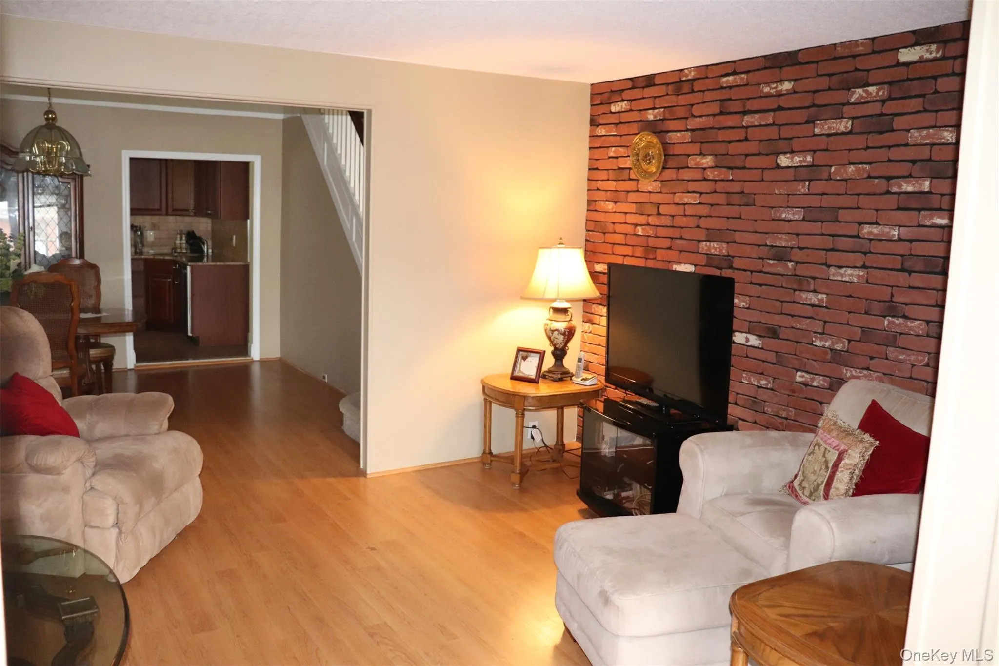 Living area featuring wood finished floors and a chandelier Living area featuring wood finished floors and a chandelier