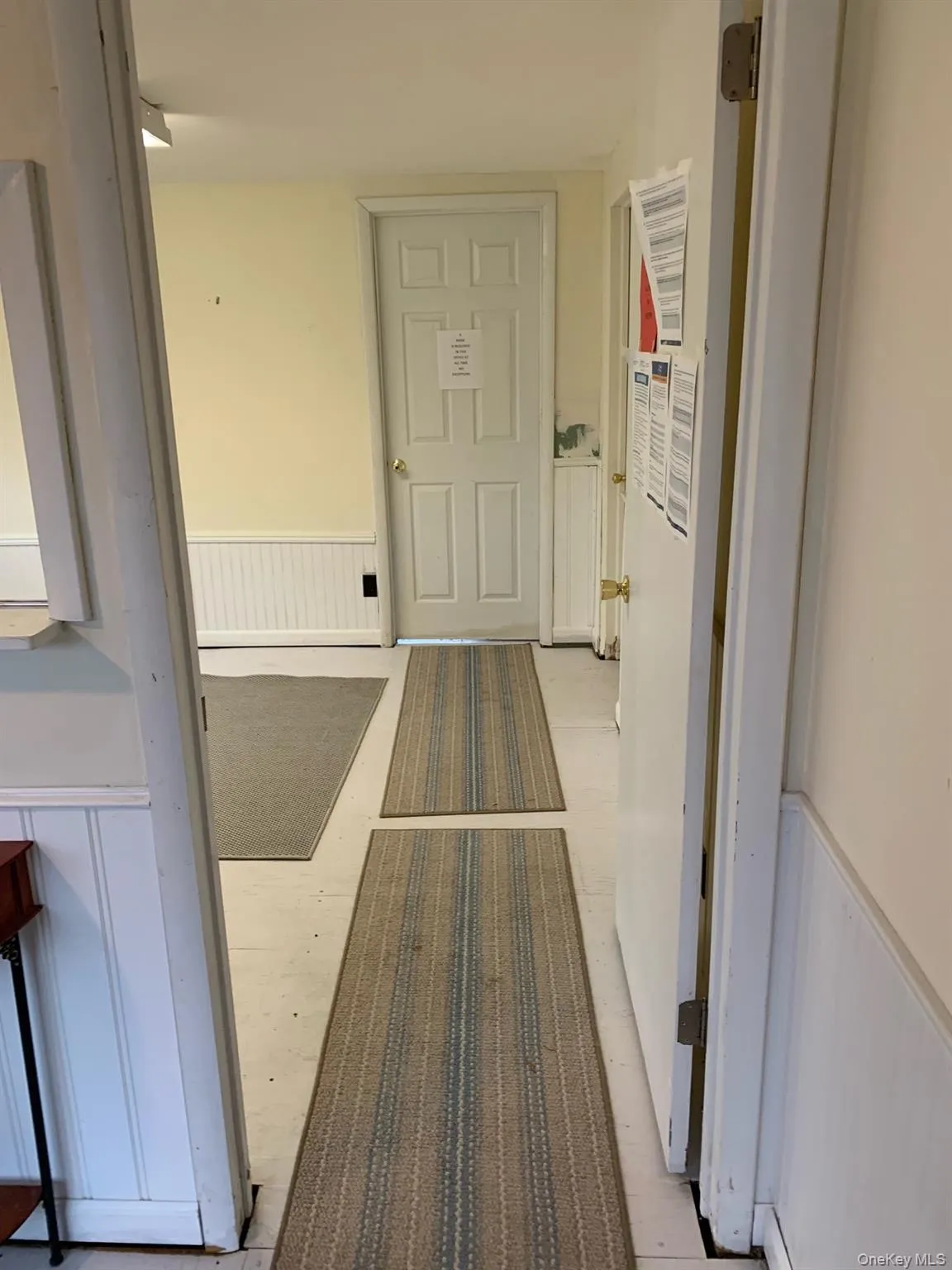 Hall featuring a wainscoted wall Hall featuring a wainscoted wall