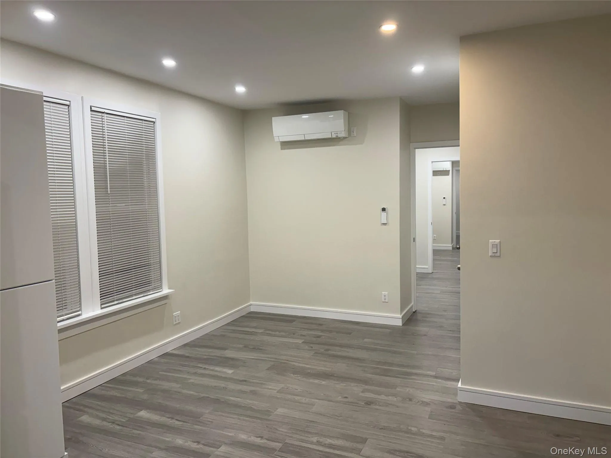 Dining Area with 2 full windows for natural light, wall mounted dual unit Dining Area with 2 full windows for natural light, wall mounted dual unit