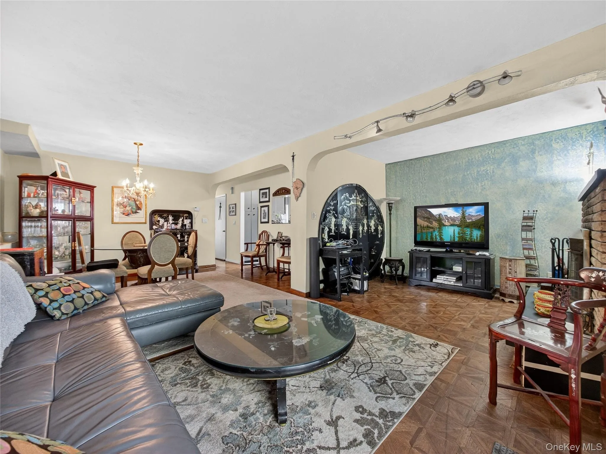 Living room with arched walkways and a chandelier Living room with arched walkways and a chandelier