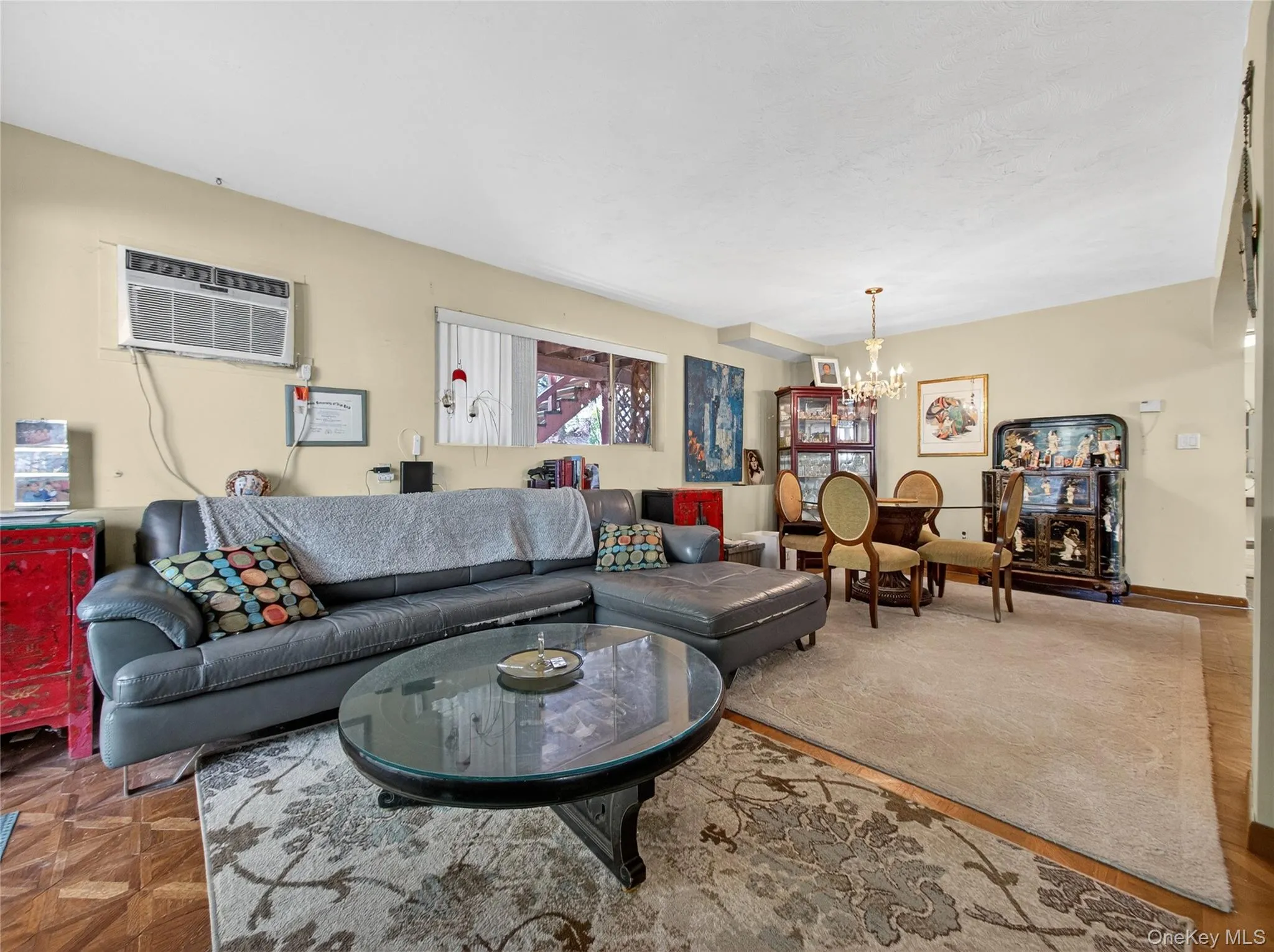 Living area with a chandelier and a wall unit AC Living area with a chandelier and a wall unit AC