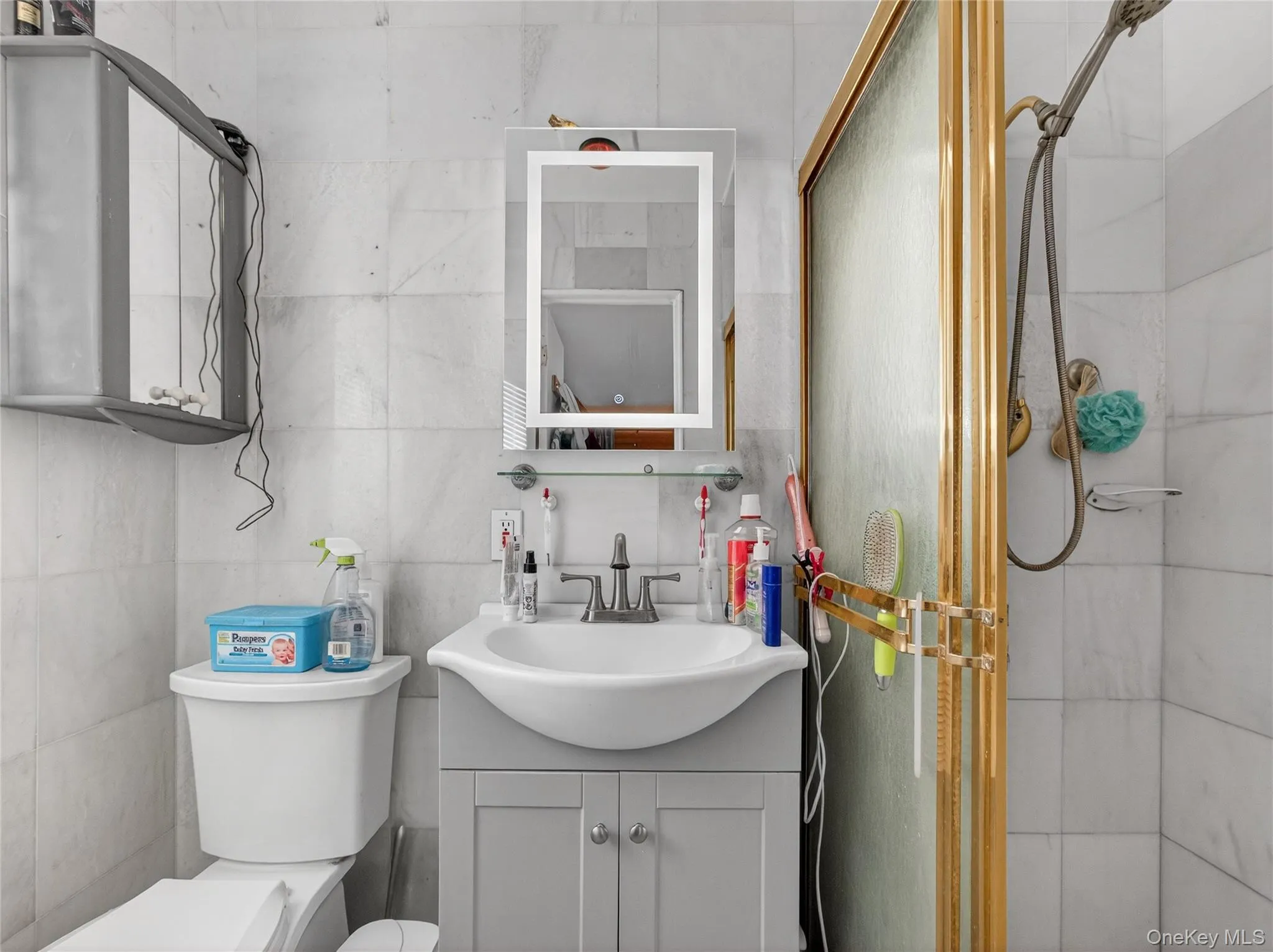 Full bath with a stall shower, tile walls, and vanity Full bath with a stall shower, tile walls, and vanity