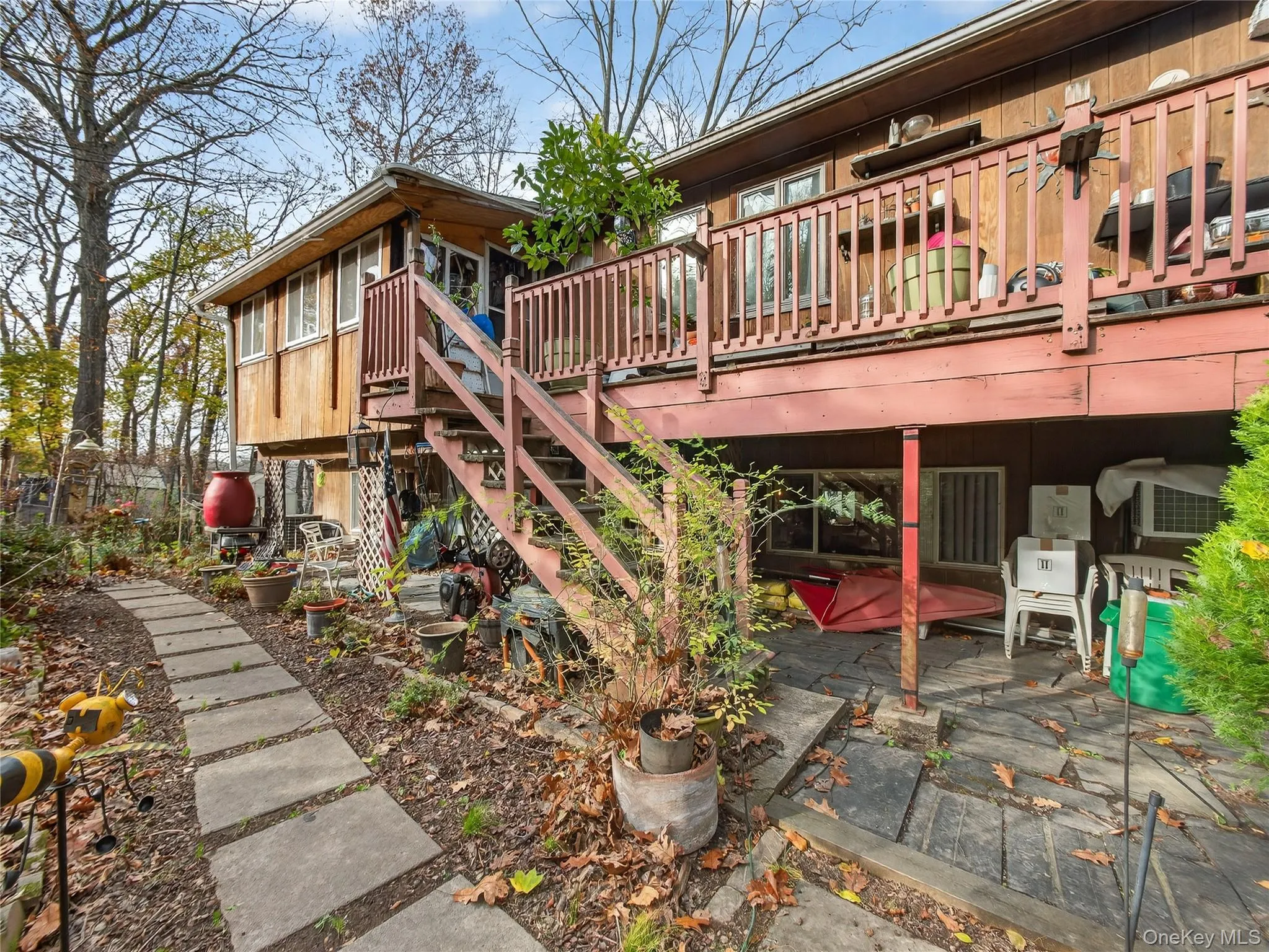 Wooden deck featuring stairs and a patio Wooden deck featuring stairs and a patio
