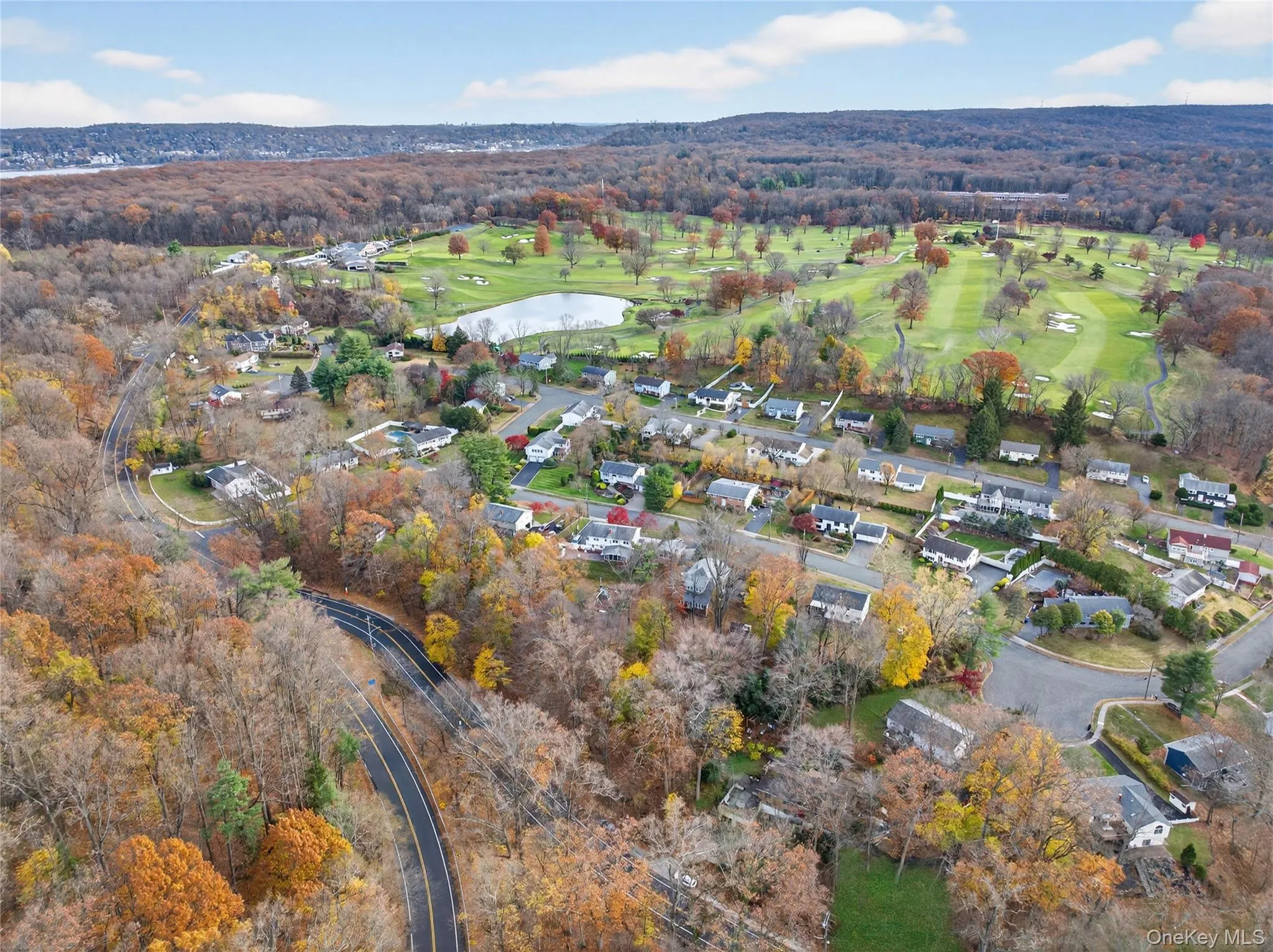 Aerial view of property and surrounding area featuring a nearby body of water and nearby suburban area Aerial view of property and surrounding area featuring a nearby body of water and nearby suburban area