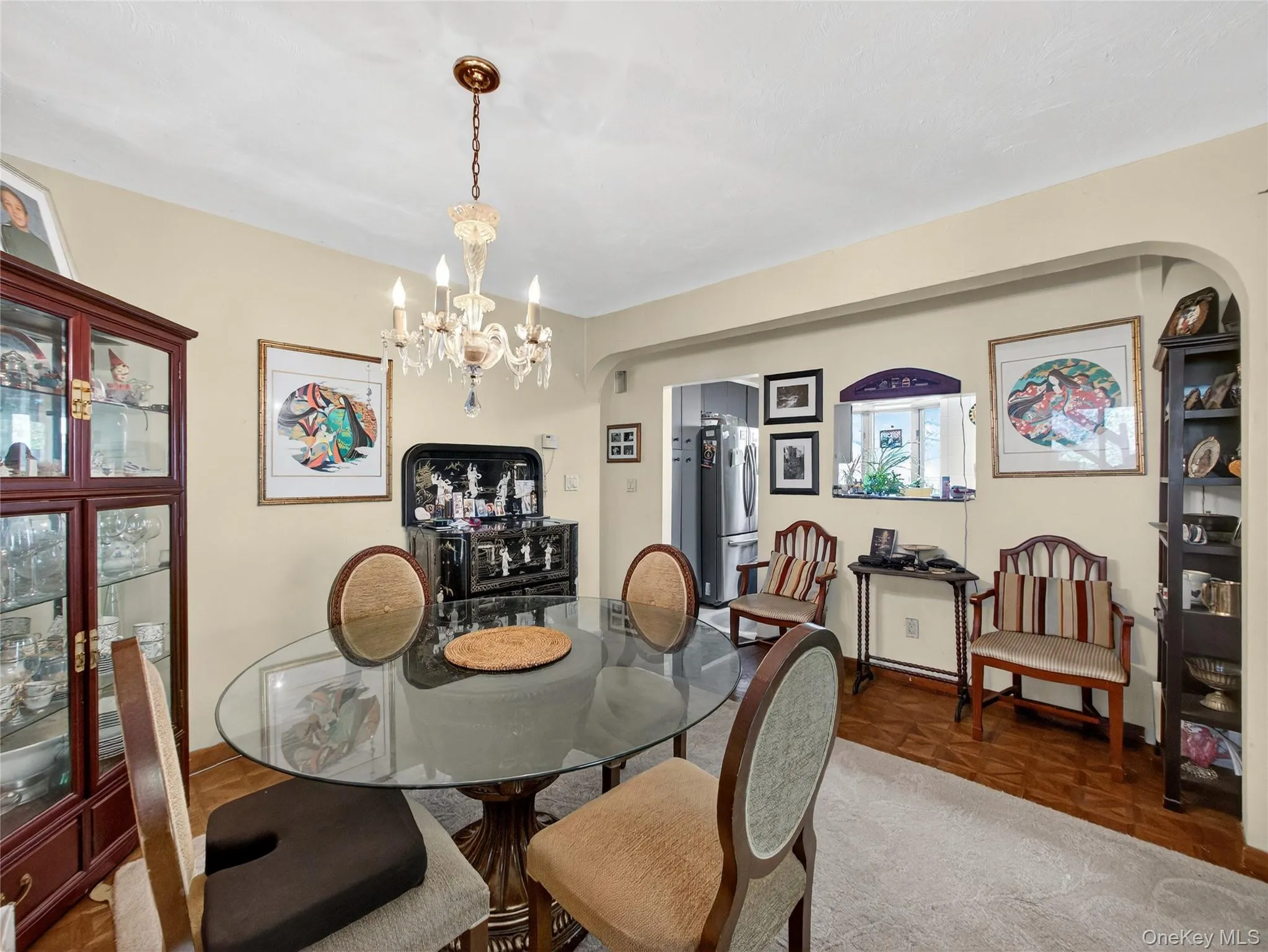 Dining room featuring arched walkways and a chandelier Dining room featuring arched walkways and a chandelier