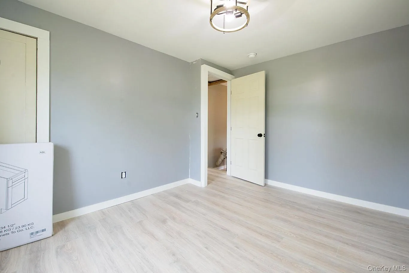 Empty room with light wood-style flooring and baseboards Empty room with light wood-style flooring and baseboards