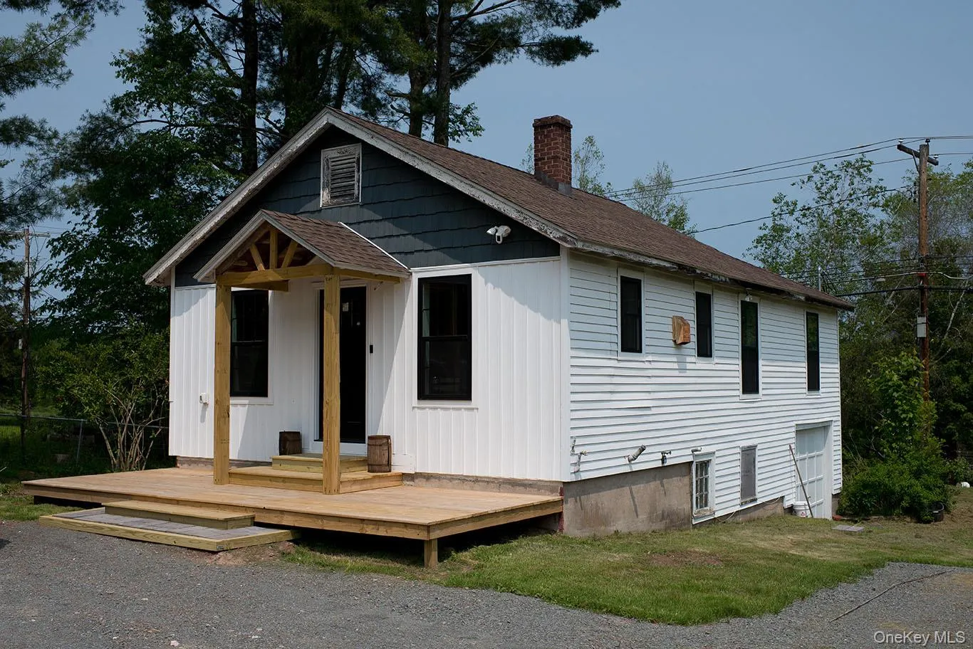 View of front of property with roof with shingles, a chimney, a deck, and board and batten siding View of front of property with roof with shingles, a chimney, a deck, and board and batten siding
