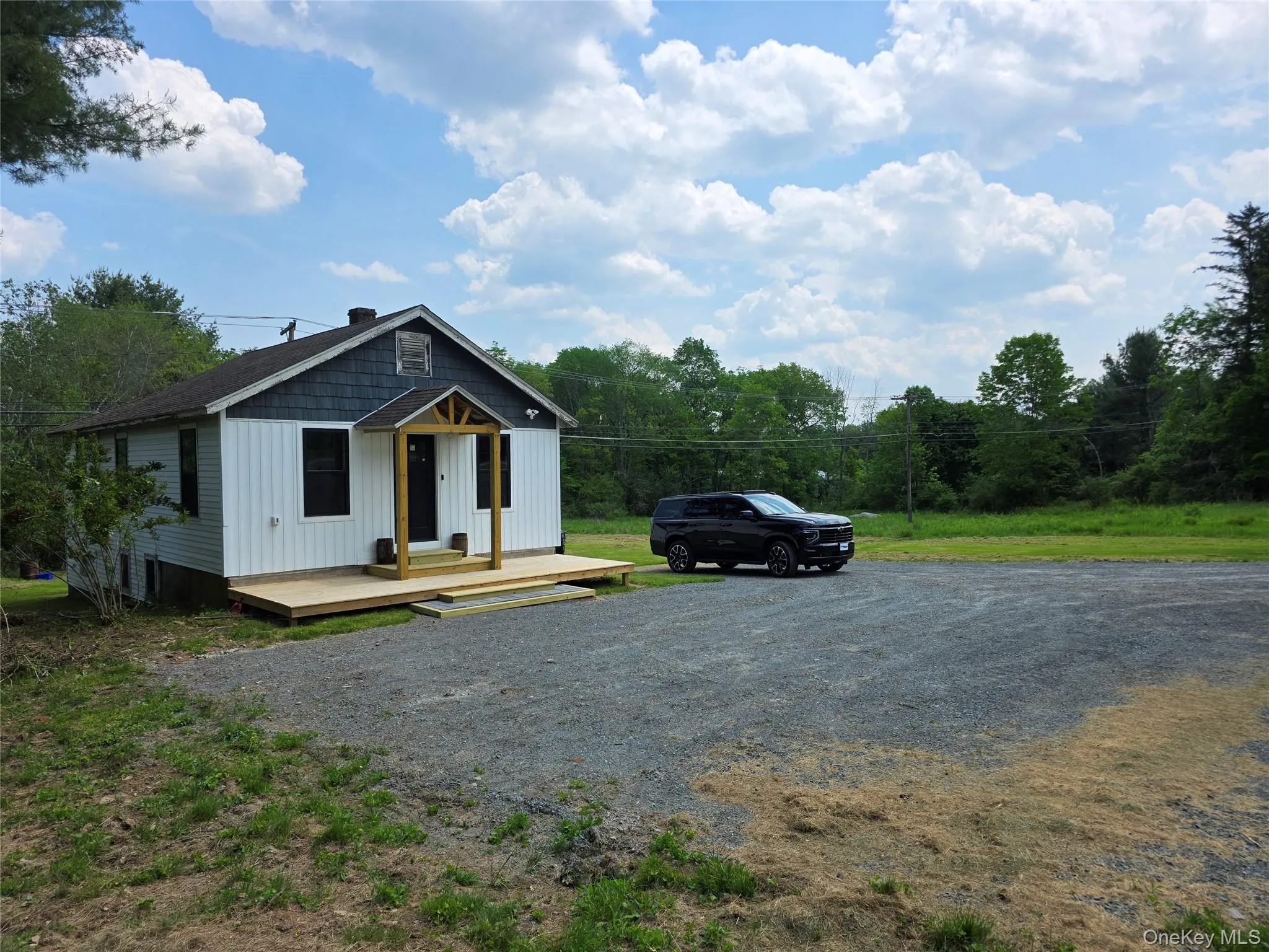 View of front of home featuring board and batten siding and a chimney View of front of home featuring board and batten siding and a chimney