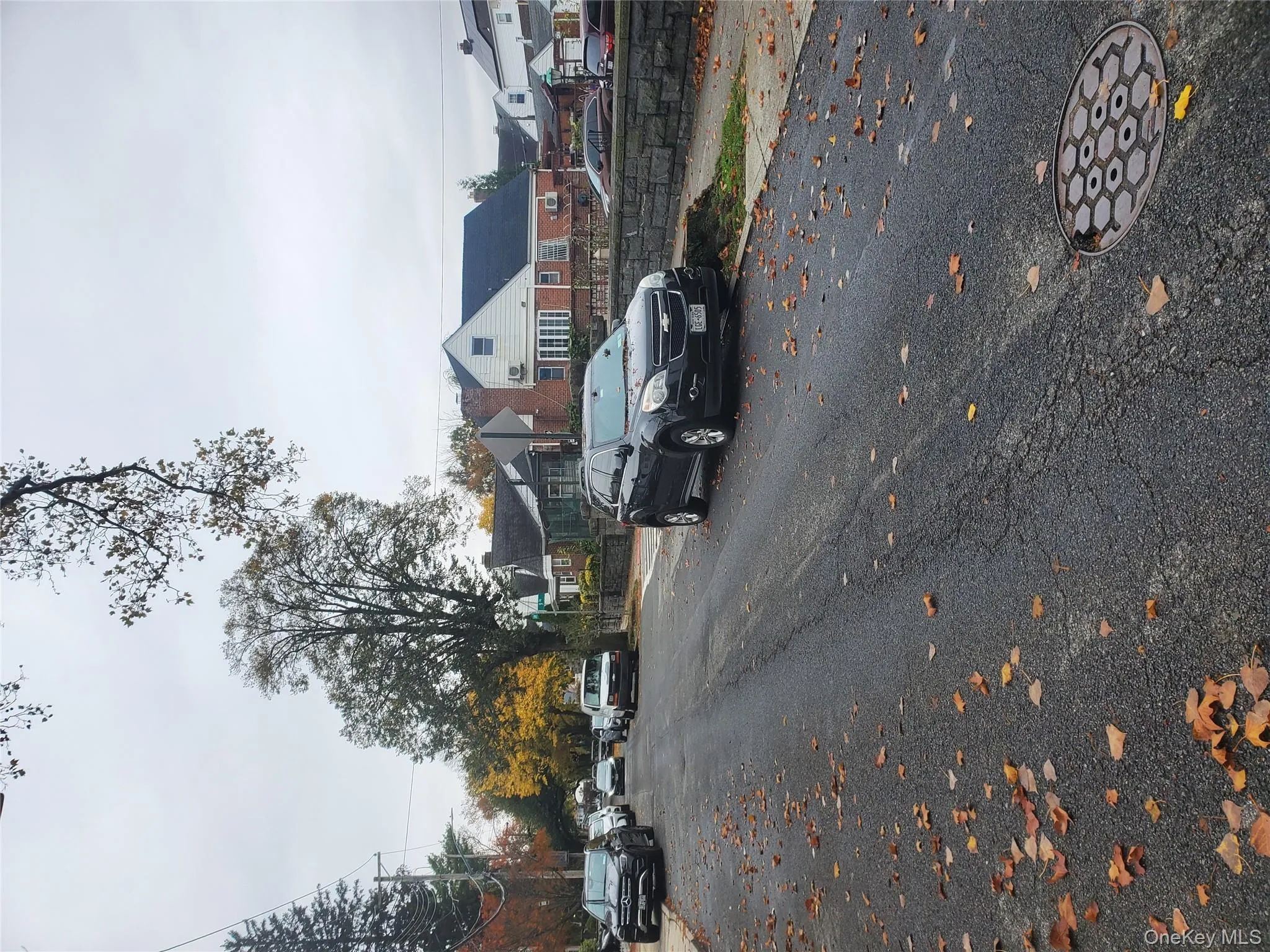 View of asphalt street with a residential view, curbs, and sidewalks View of asphalt street with a residential view, curbs, and sidewalks