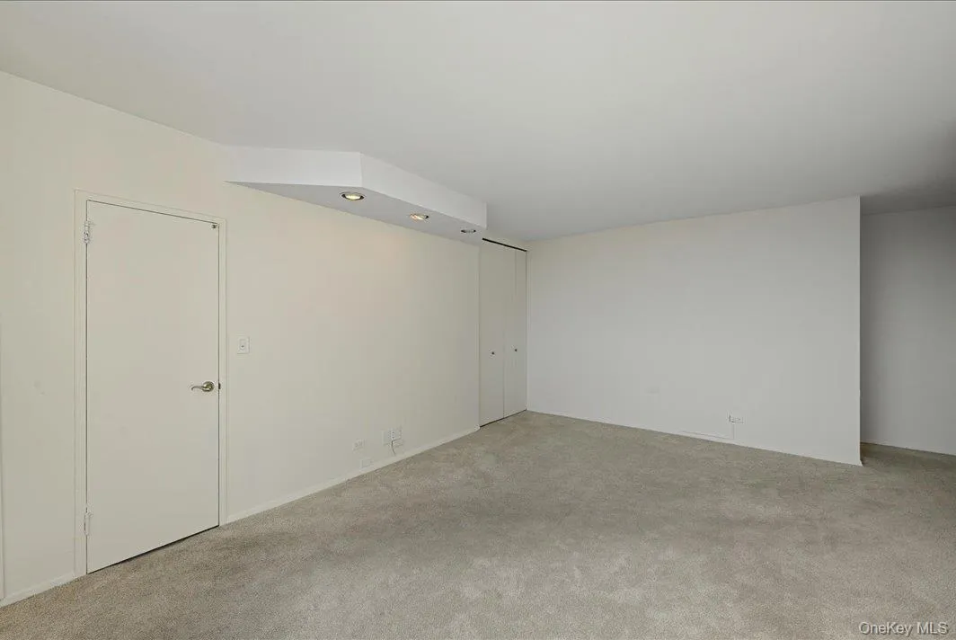 Empty room featuring carpet flooring Empty room featuring carpet flooring