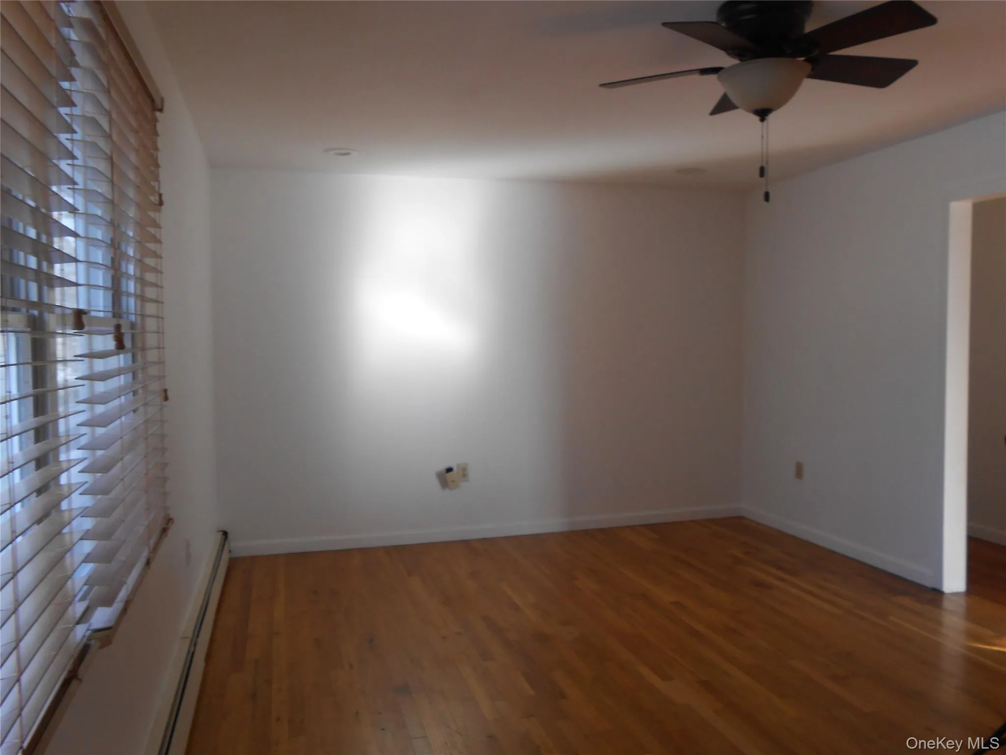 18 x 12 Livingroom, closet, wall of windows facing front of house, ceiling fan, wood floors 18 x 12 Livingroom, closet, wall of windows facing front of house, ceiling fan, wood floors