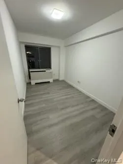 Unfurnished room featuring light wood-type flooring and baseboards Unfurnished room featuring light wood-type flooring and baseboards