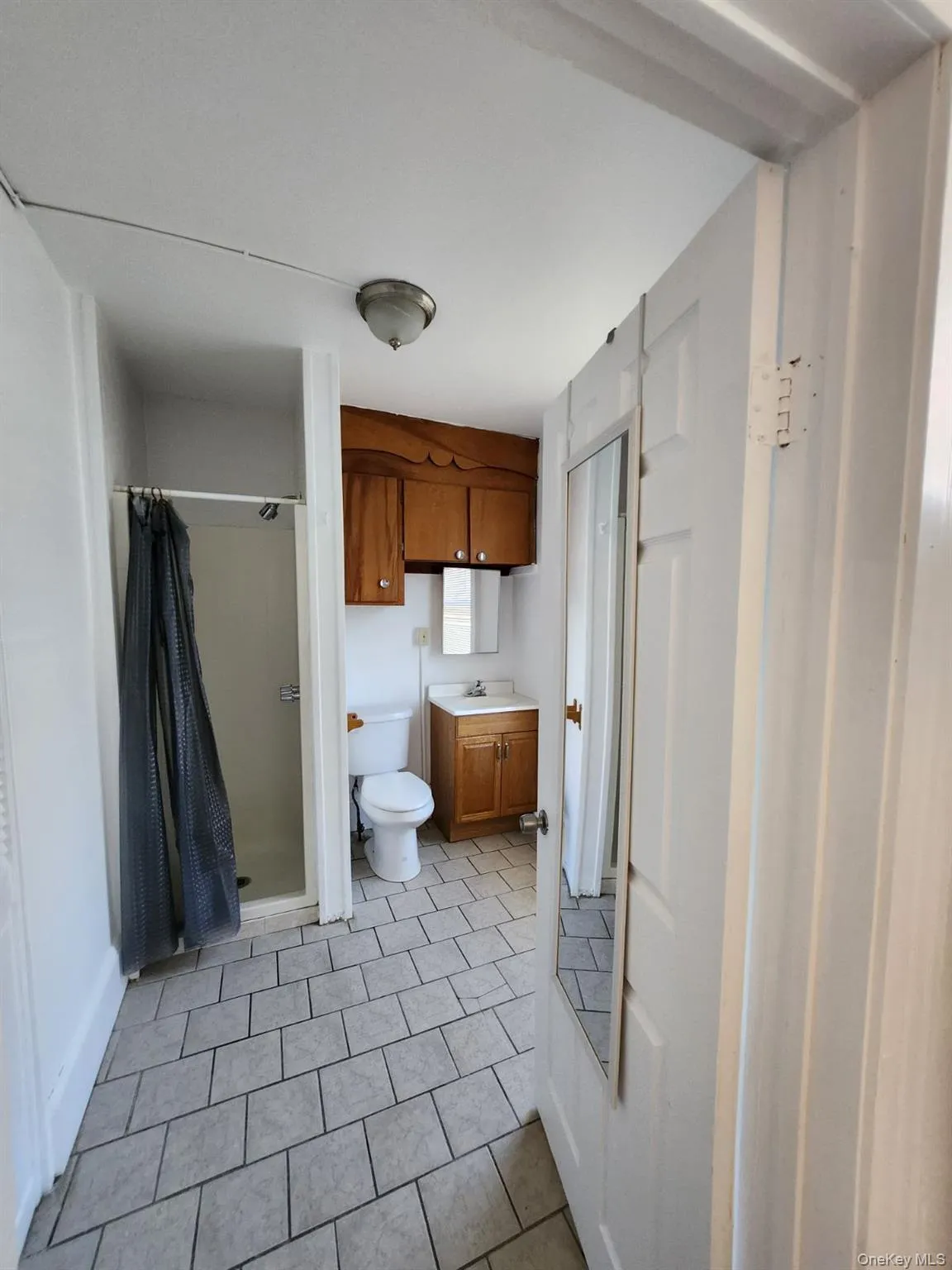 Bathroom with vanity, a stall shower, and light tile patterned flooring Bathroom with vanity, a stall shower, and light tile patterned flooring