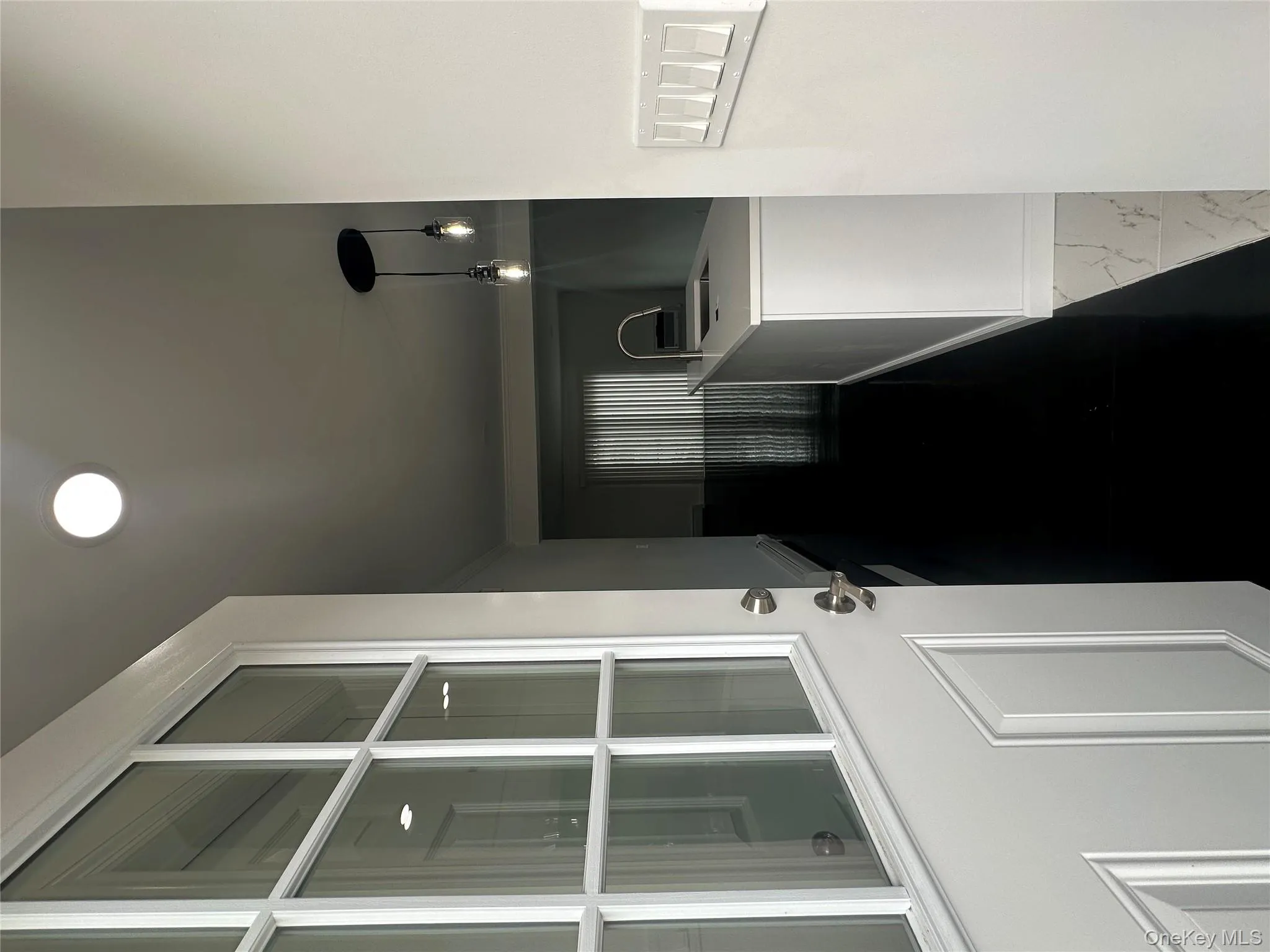 Hallway with a sink and dark marble finish floors Hallway with a sink and dark marble finish floors