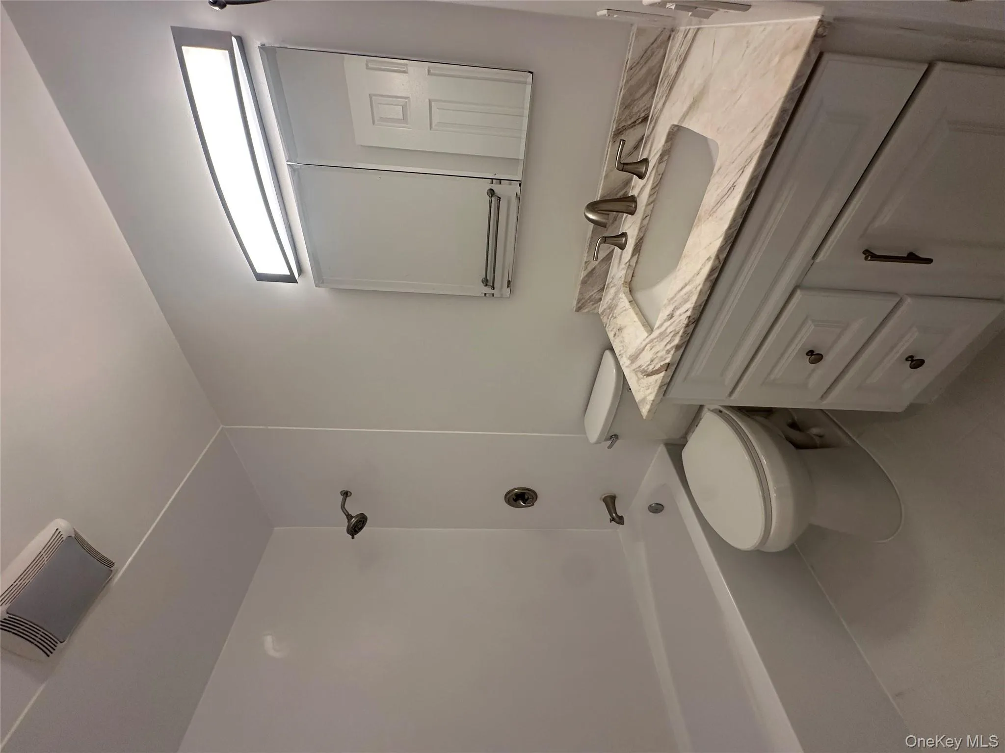 Bathroom with vanity, shower / tub combination, and light tile patterned floors Bathroom with vanity, shower / tub combination, and light tile patterned floors