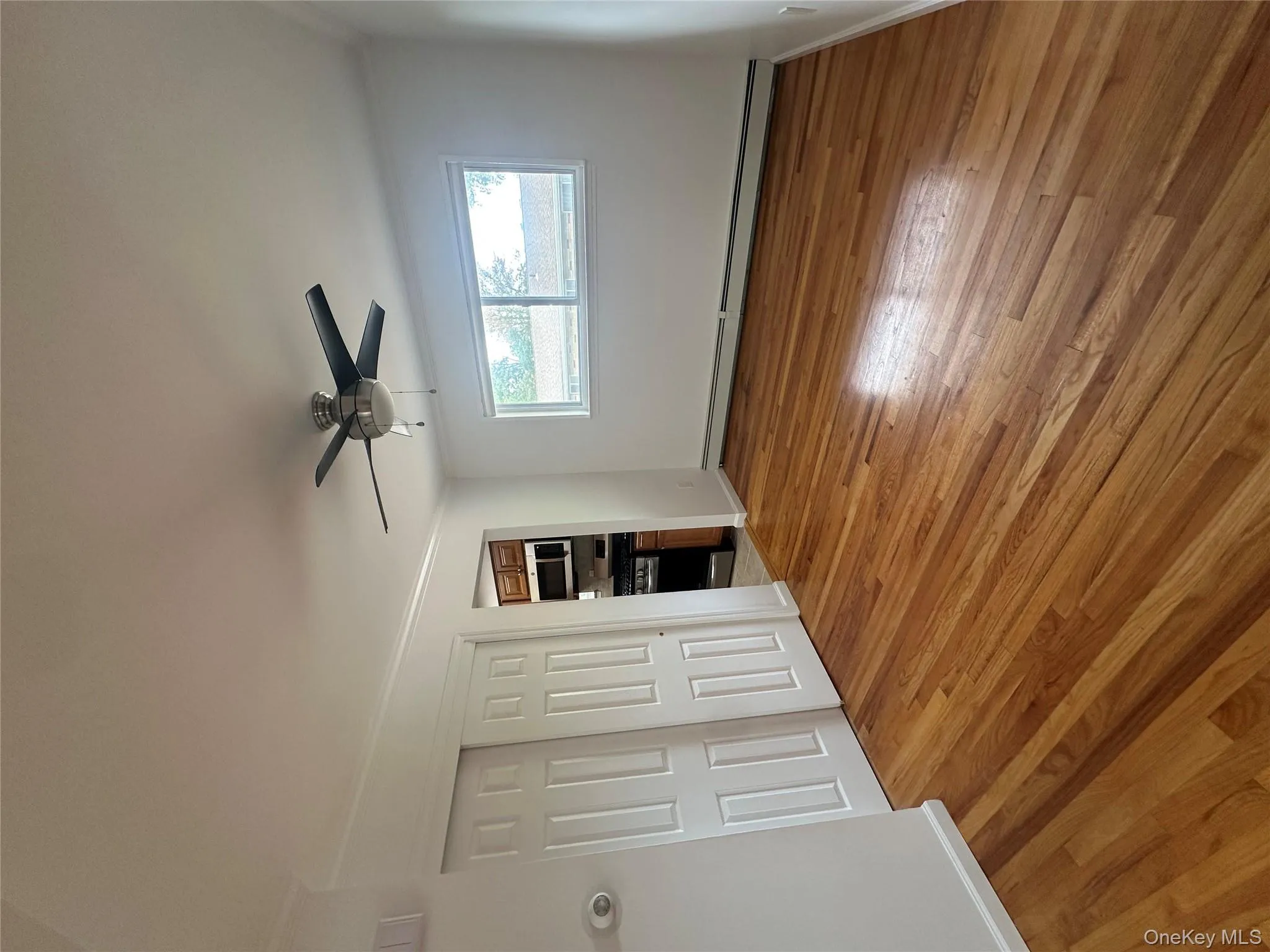 Unfurnished bedroom with ornamental molding, light wood-type flooring, baseboard heating, a closet, and a ceiling fan Unfurnished bedroom with ornamental molding, light wood-type flooring, baseboard heating, a closet, and a ceiling fan