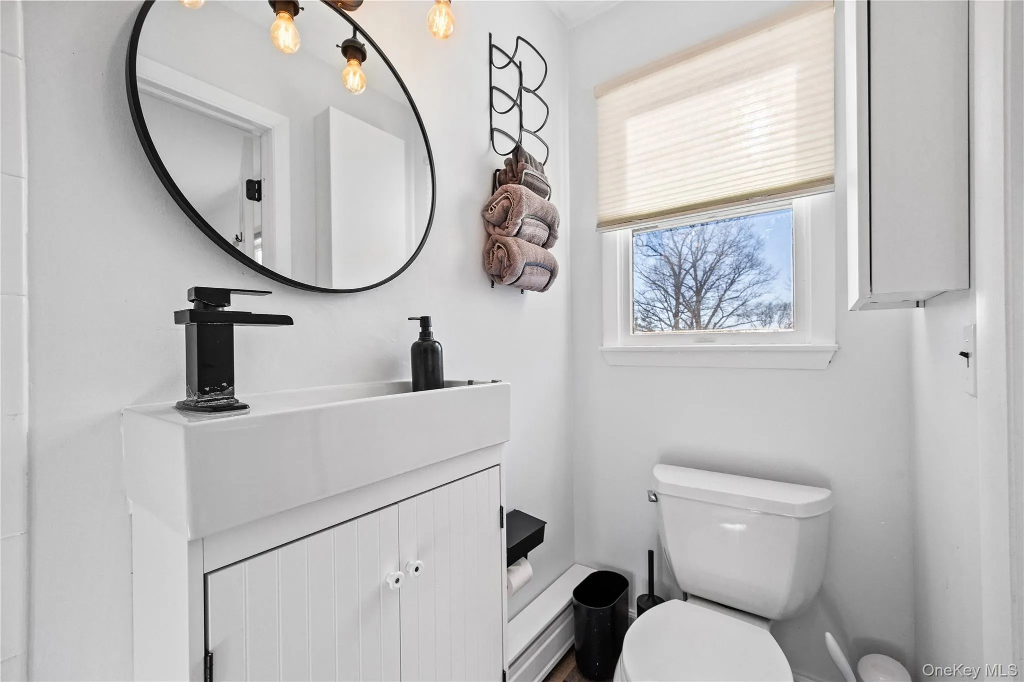 Half bath with vanity and toilet Half bath with vanity and toilet