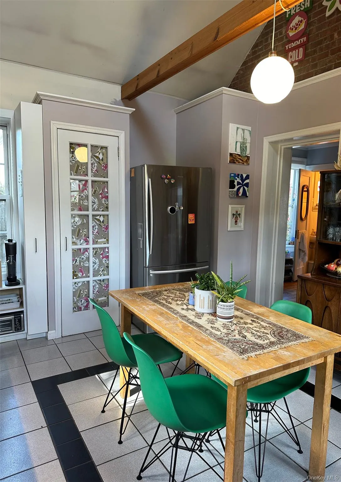 Tiled dining area featuring beam ceiling Tiled dining area featuring beam ceiling