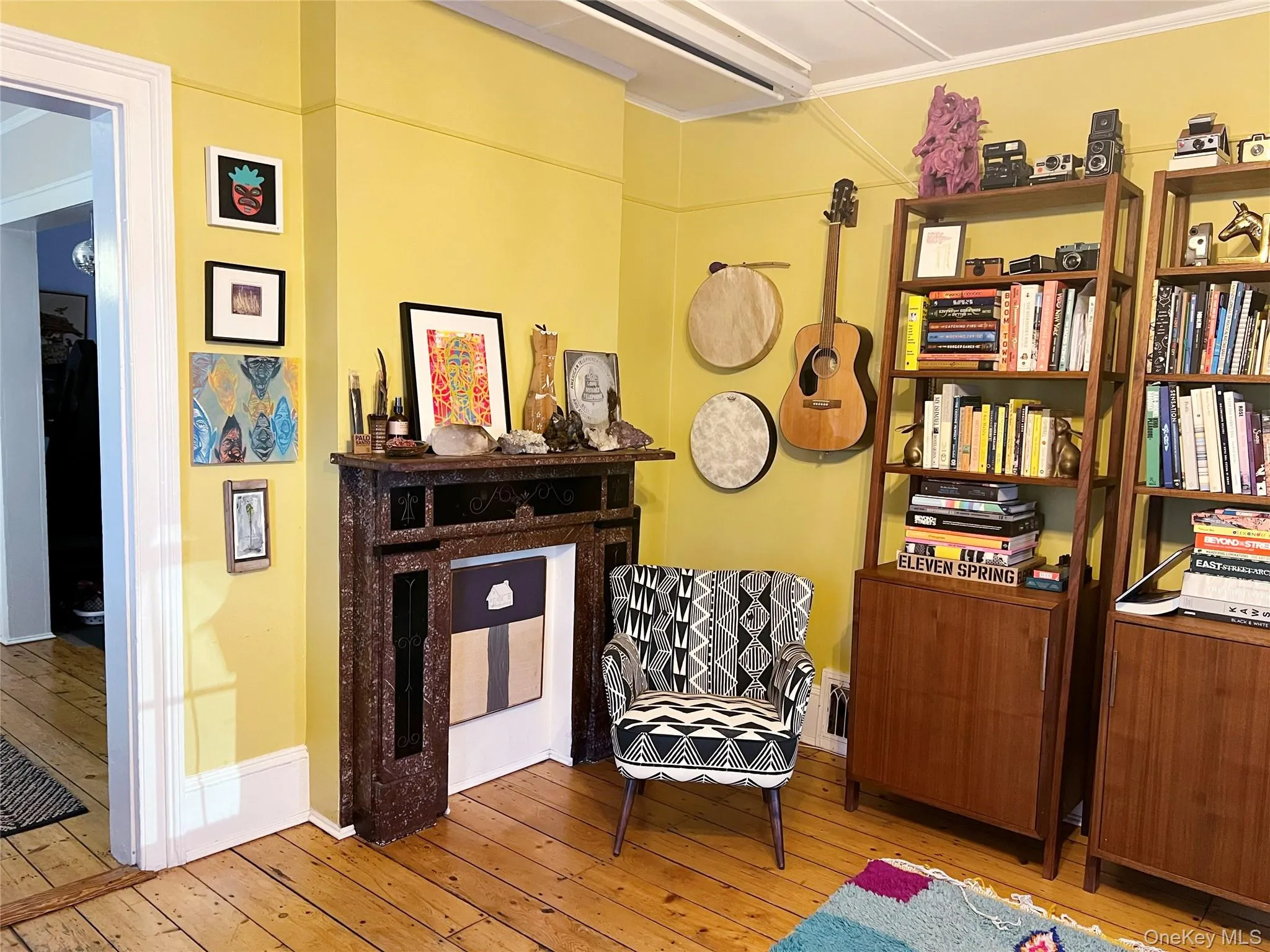 Living area featuring hardwood / wood-style flooring and baseboards Living area featuring hardwood / wood-style flooring and baseboards