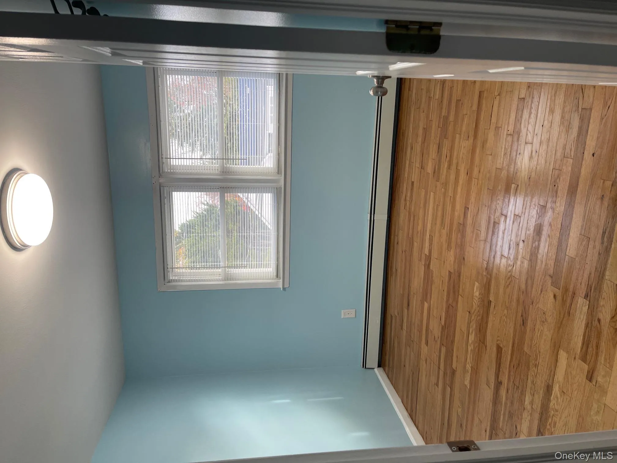 Spare room featuring light wood-type flooring and a baseboard radiator Spare room featuring light wood-type flooring and a baseboard radiator