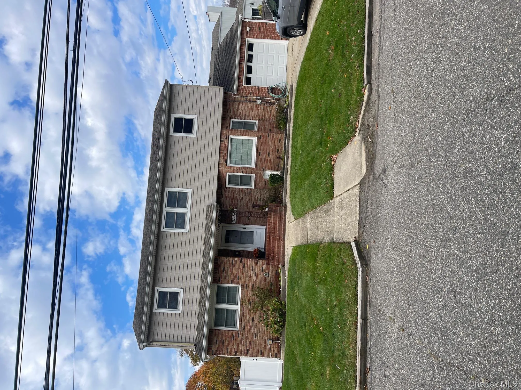 View of front facade with brick siding and an attached garage View of front facade with brick siding and an attached garage