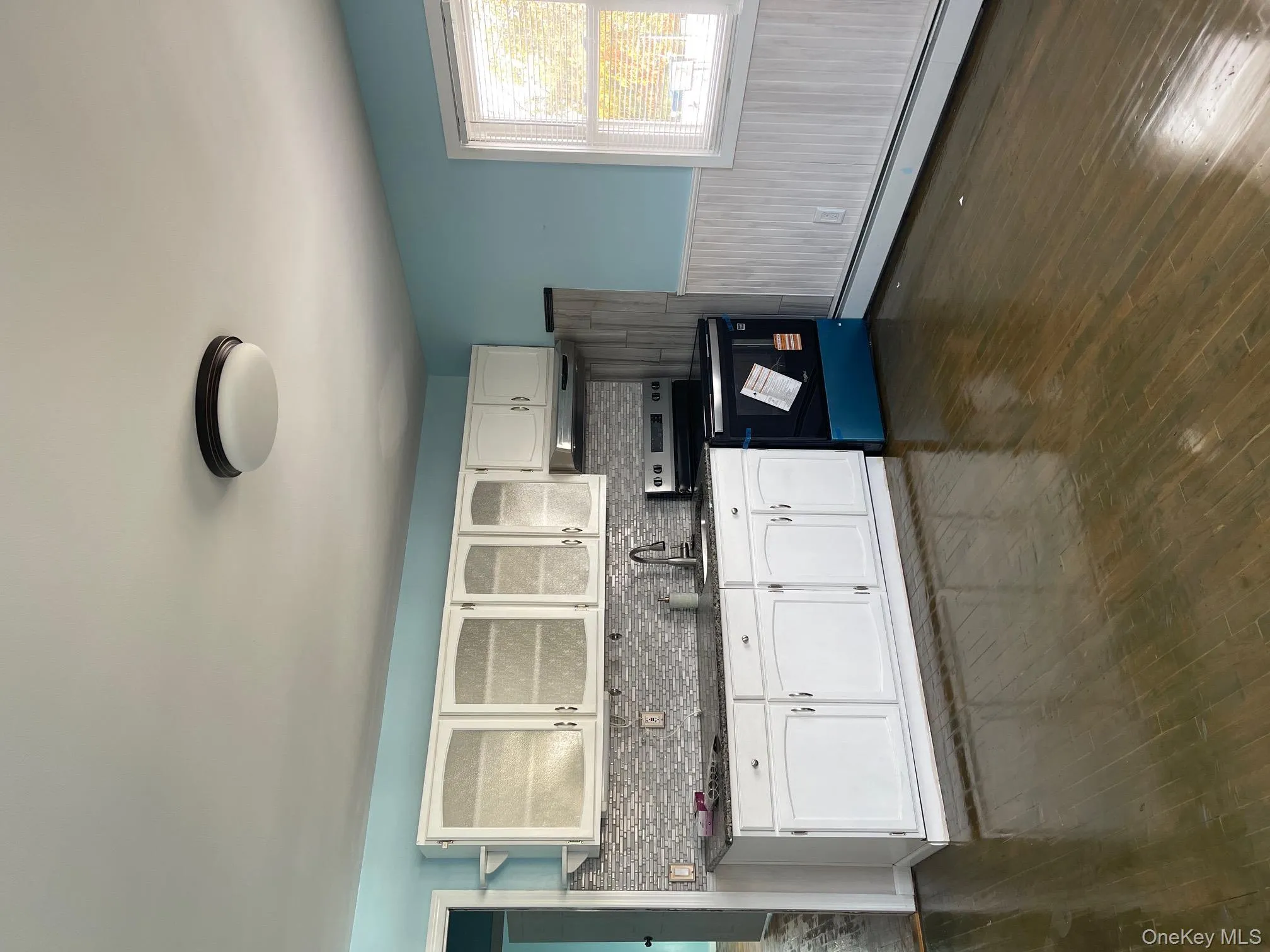Kitchen featuring white cabinetry, electric stove, baseboard heating, glass insert cabinets, and dark wood-style flooring Kitchen featuring white cabinetry, electric stove, baseboard heating, glass insert cabinets, and dark wood-style flooring