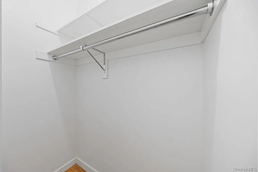 Spacious closet with wood finished floors Spacious closet with wood finished floors