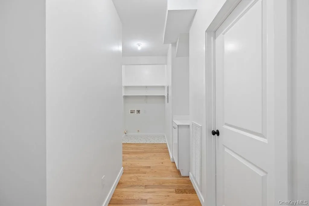 Corridor with light wood finished floors and baseboards Corridor with light wood finished floors and baseboards