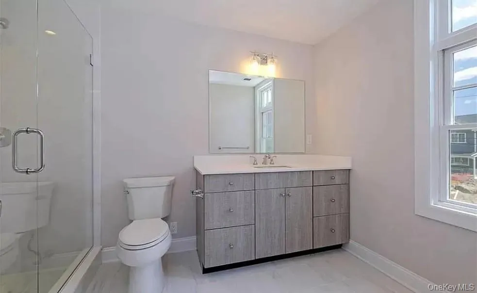 Full bath featuring vanity and a stall shower Full bath featuring vanity and a stall shower
