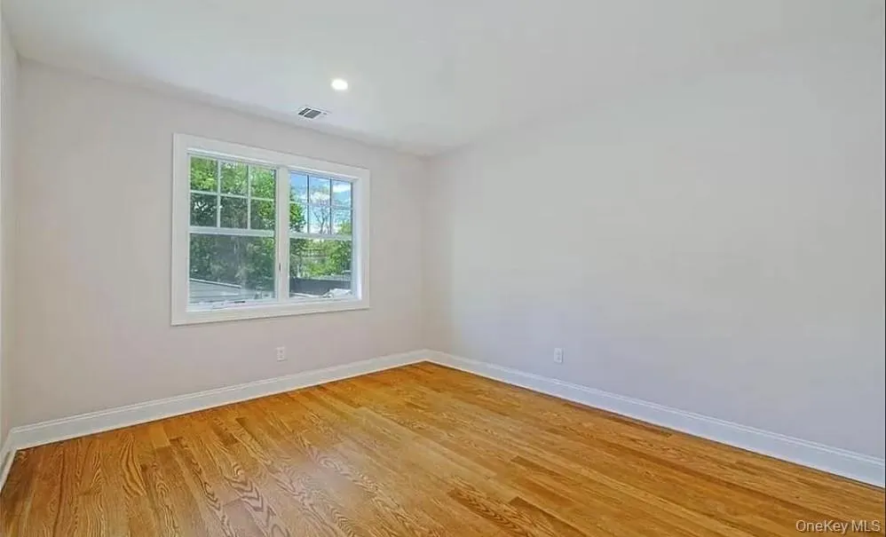 Spare room with light wood-type flooring and recessed lighting Spare room with light wood-type flooring and recessed lighting