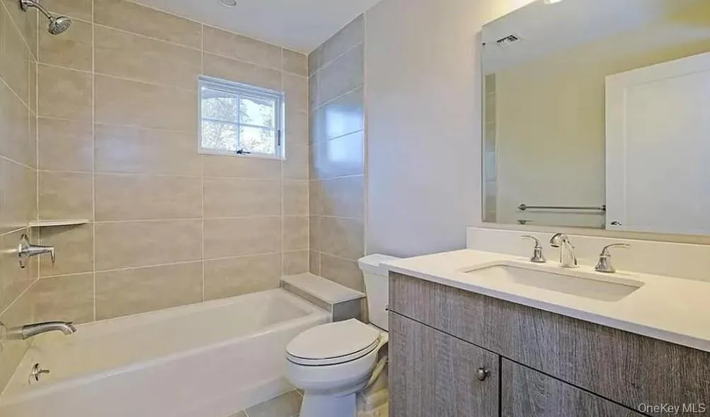 Full bathroom featuring vanity and shower combination Full bathroom featuring vanity and shower combination