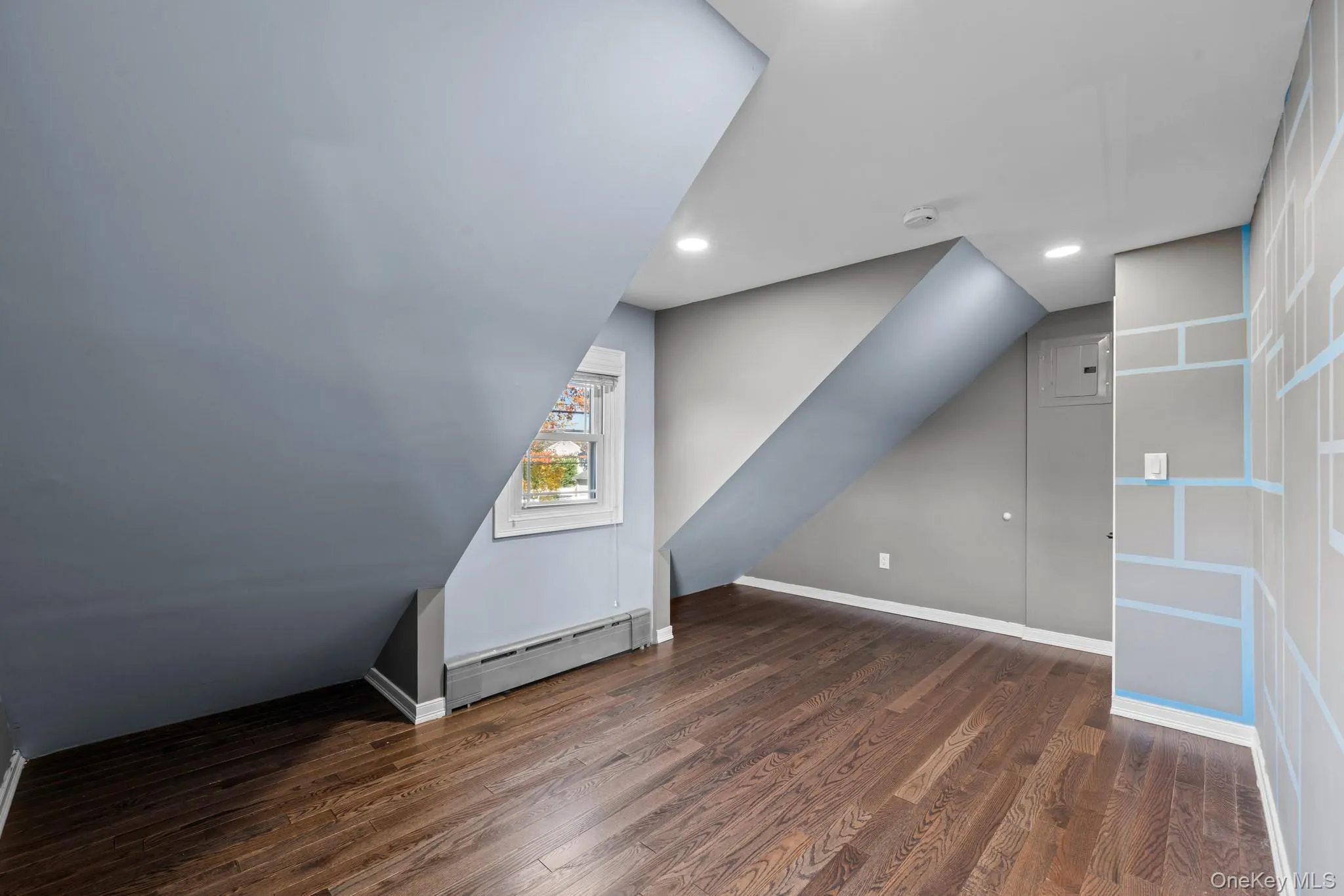 Bonus room with dark wood-style floors, a baseboard radiator, vaulted ceiling, and recessed lighting Bonus room with dark wood-style floors, a baseboard radiator, vaulted ceiling, and recessed lighting
