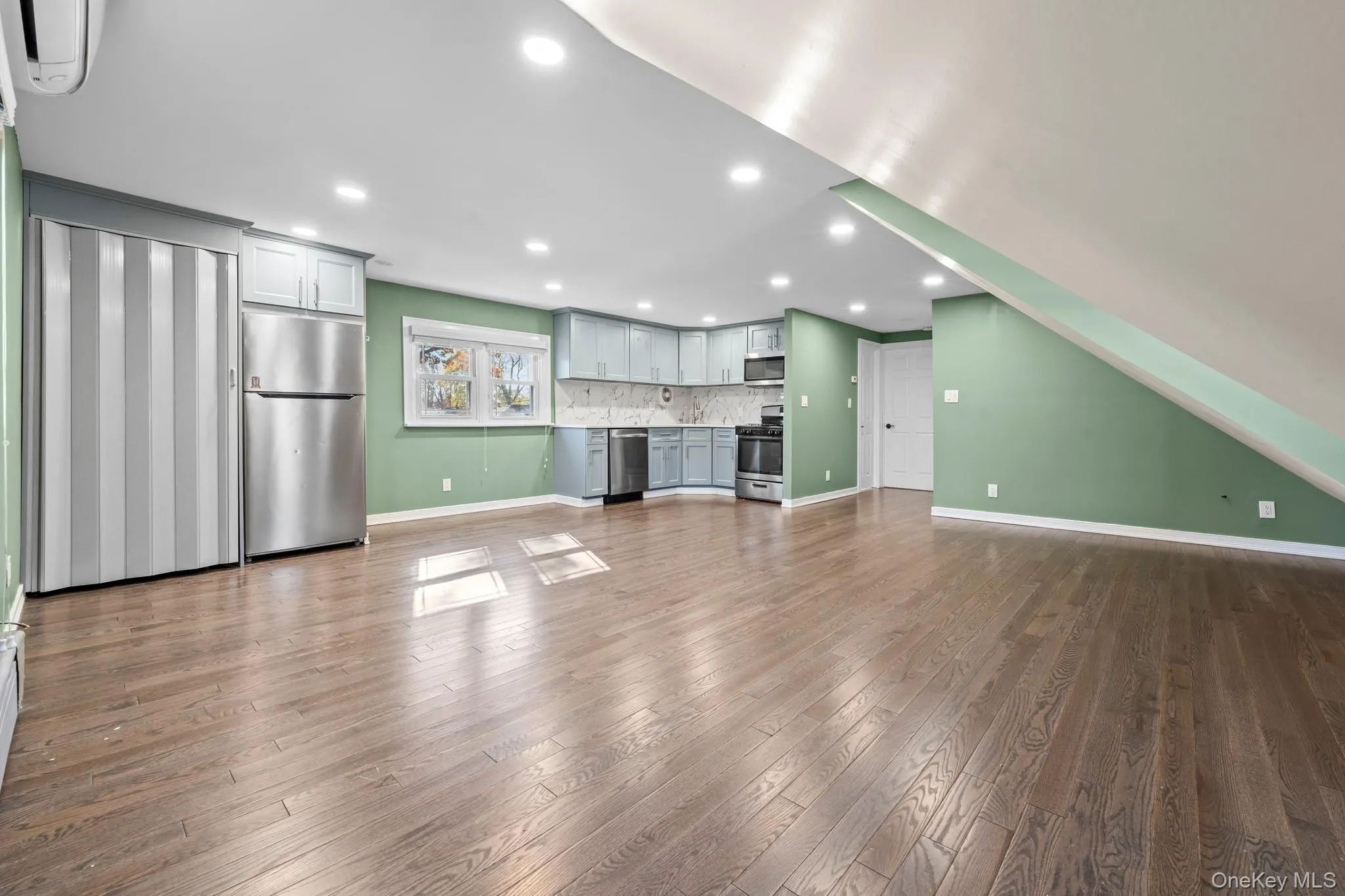 Unfurnished living room with dark wood-type flooring and recessed lighting Unfurnished living room with dark wood-type flooring and recessed lighting