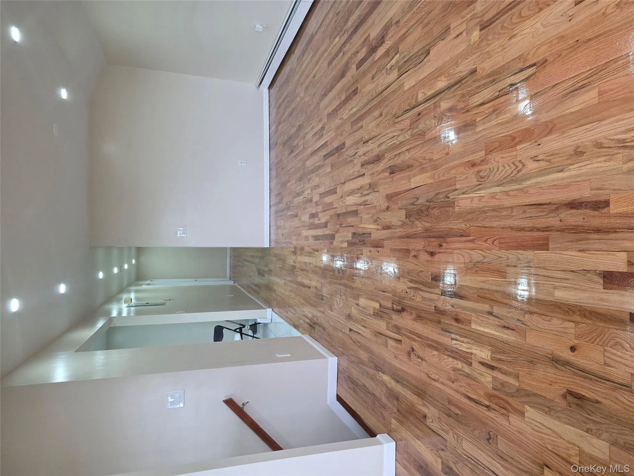 Unfurnished room featuring recessed lighting, light wood-style flooring, and baseboard heating Unfurnished room featuring recessed lighting, light wood-style flooring, and baseboard heating