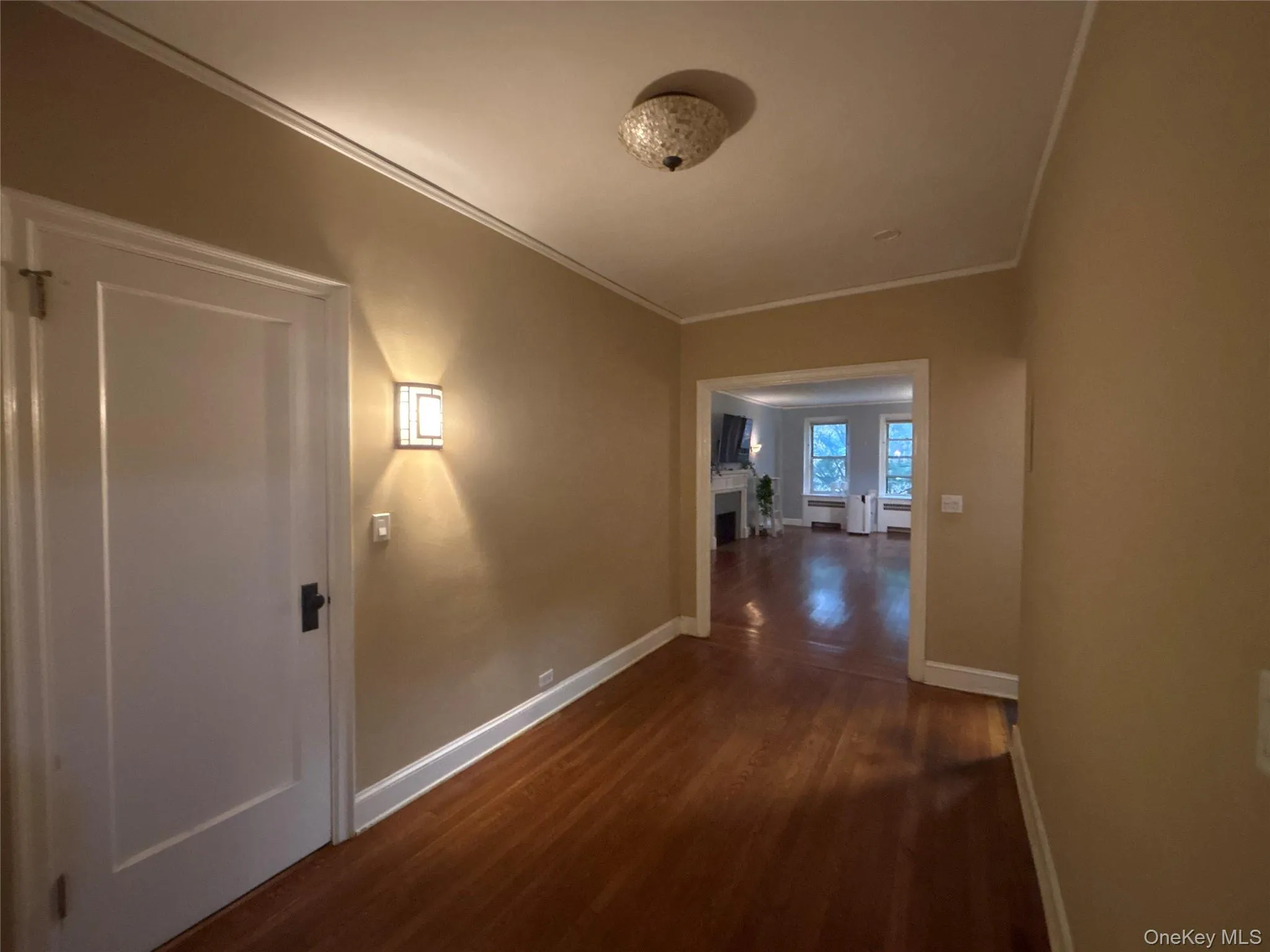 Hall featuring crown molding and dark wood-type flooring Hall featuring crown molding and dark wood-type flooring