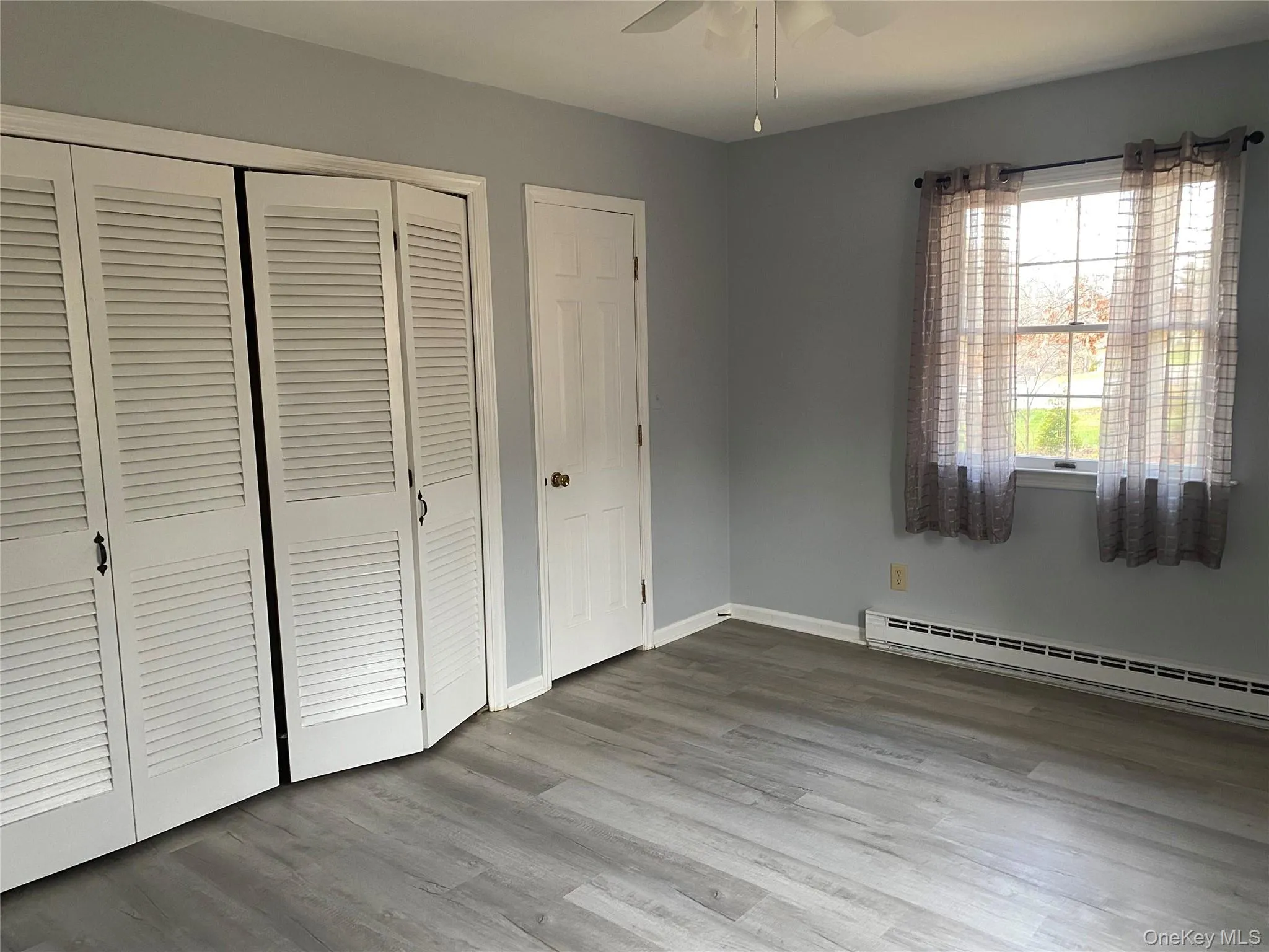 Bedroom with multiple closets and ceiling fan Bedroom with multiple closets and ceiling fan
