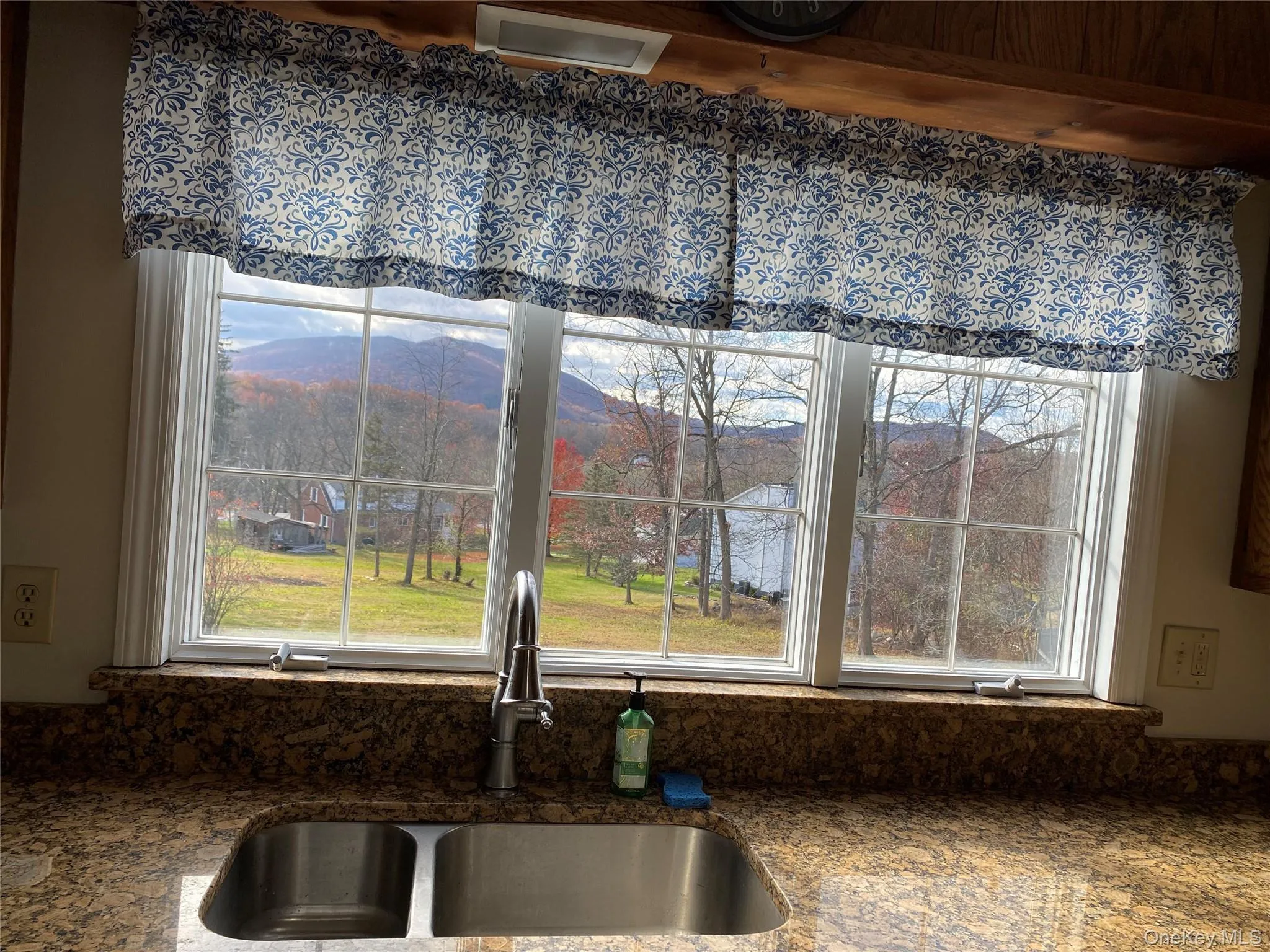 Kitchen view of mountains and dark stone countertops Kitchen view of mountains and dark stone countertops