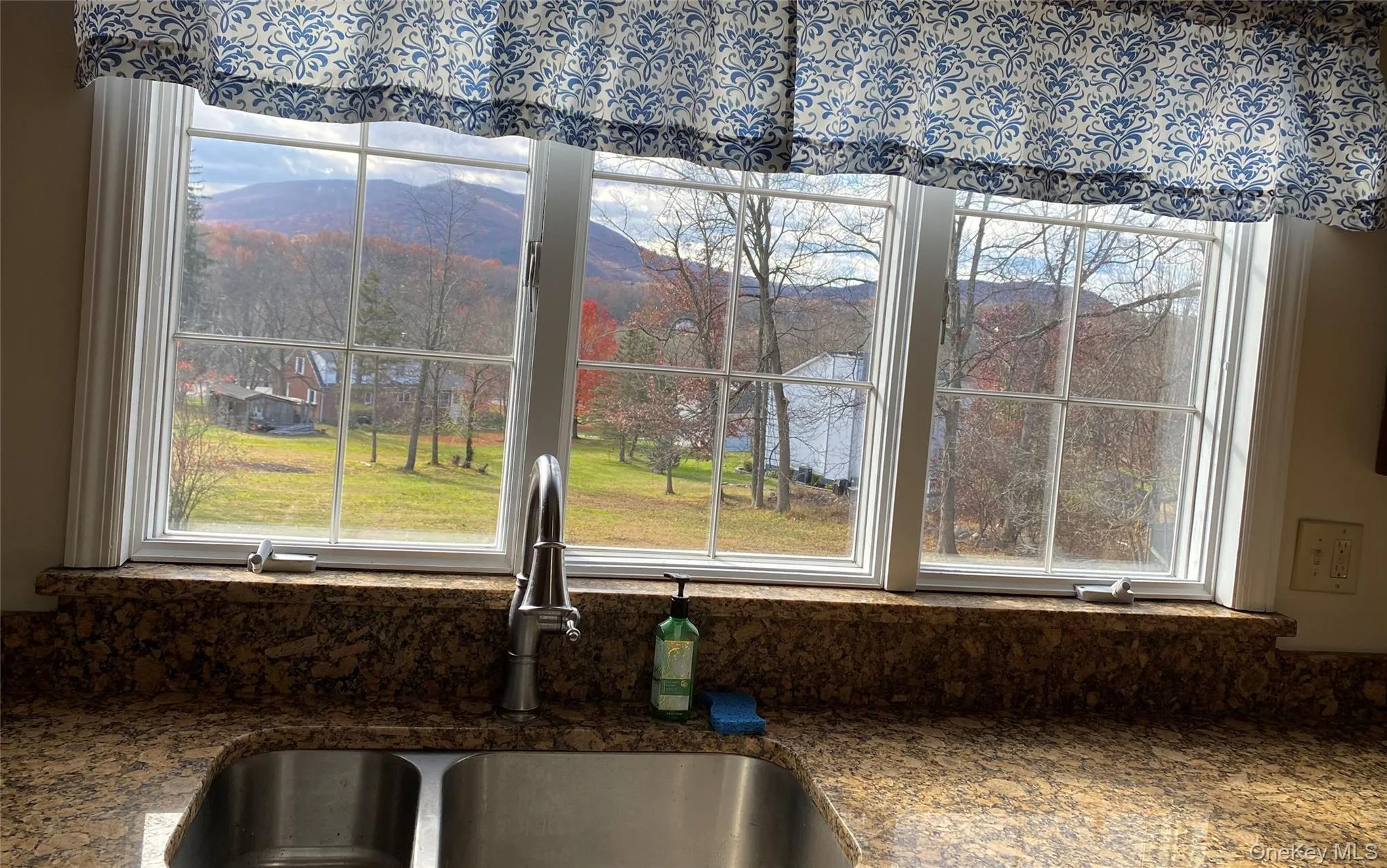 Kitchen view of dark stone countertops and mountains Kitchen view of dark stone countertops and mountains