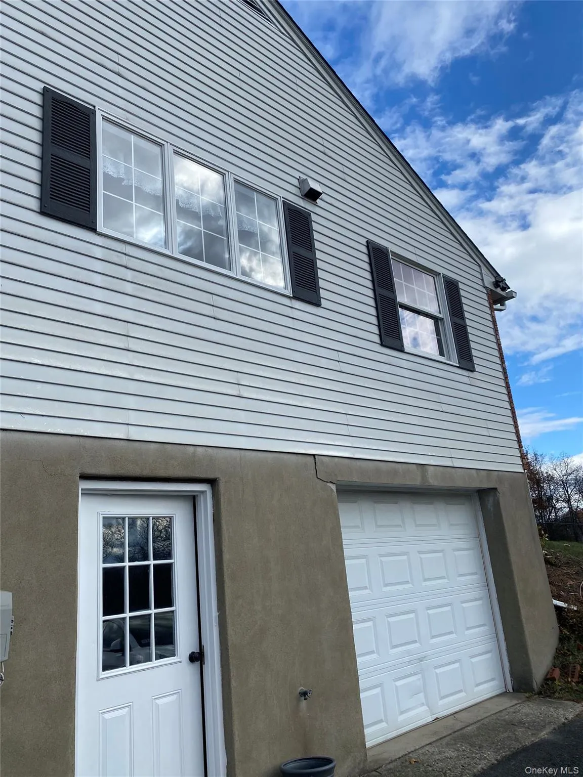 View of property exterior featuring stucco siding View of property exterior featuring stucco siding