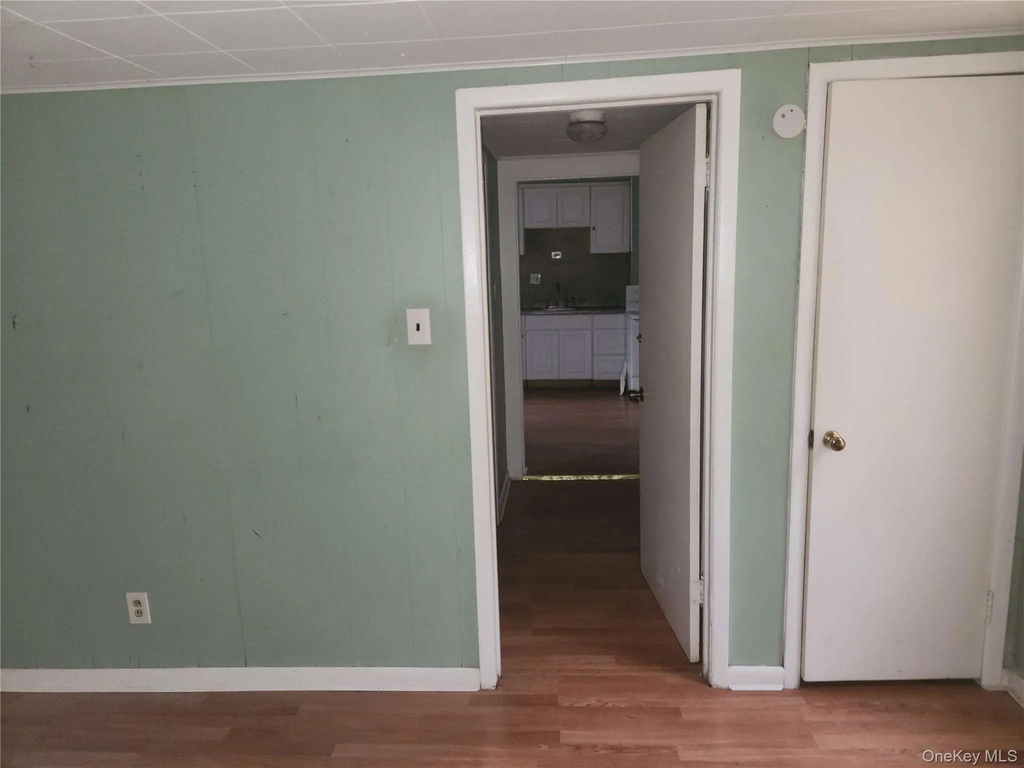 Hall with dark wood-style floors and ornamental molding Hall with dark wood-style floors and ornamental molding