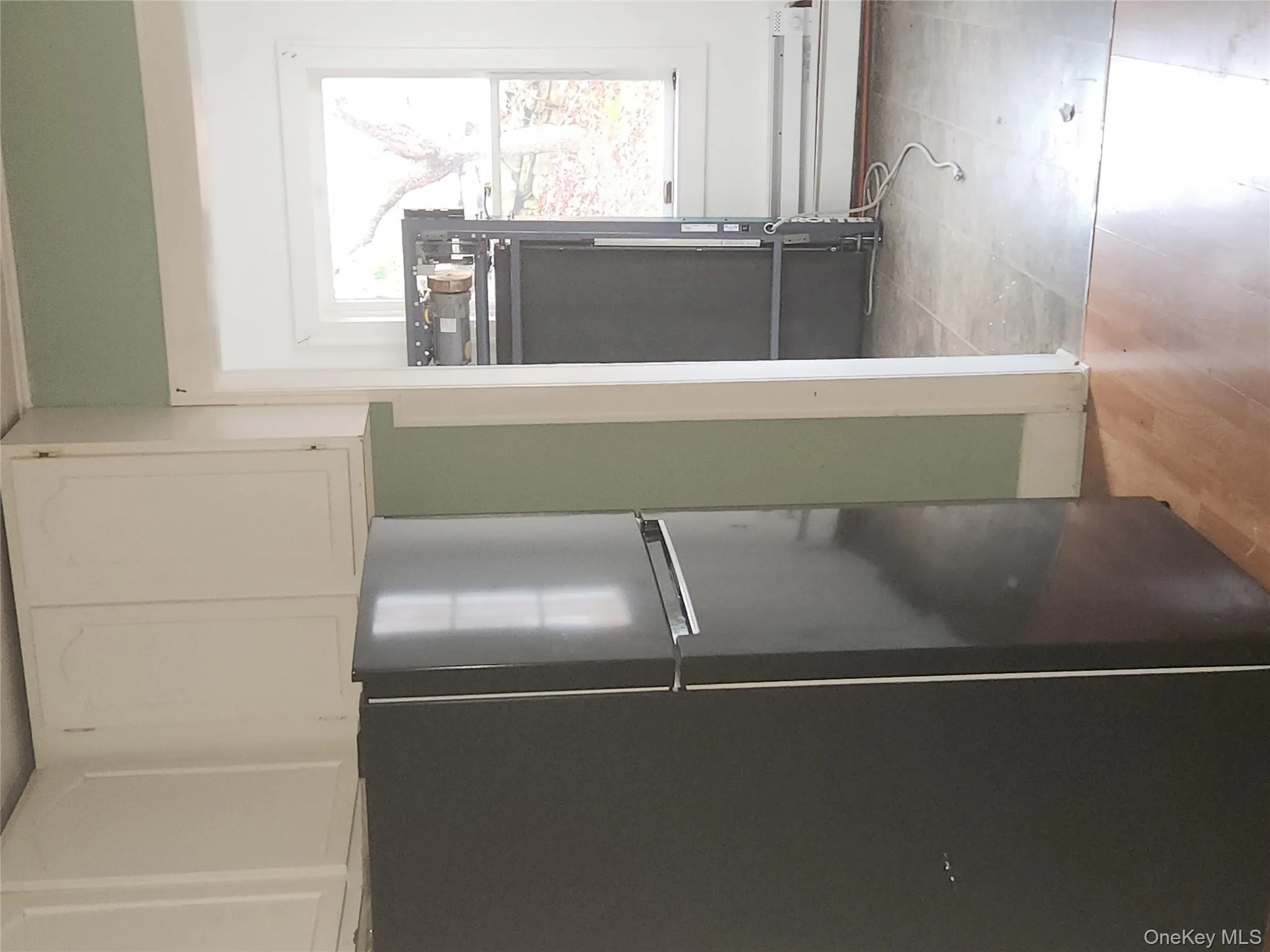 Kitchen featuring freestanding refrigerator, white cabinetry, and light wood-type flooring Kitchen featuring freestanding refrigerator, white cabinetry, and light wood-type flooring