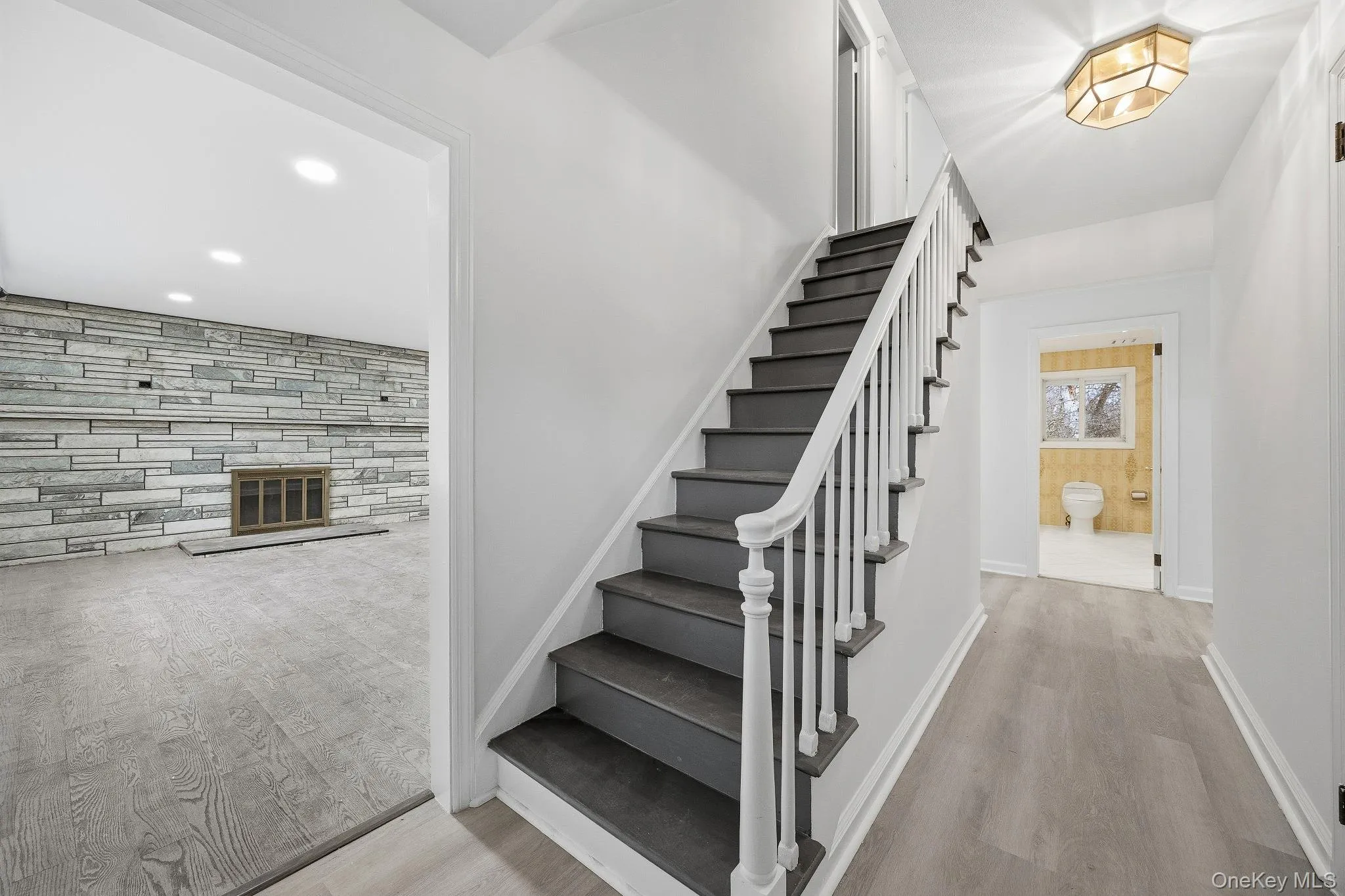 Stairs with wood finished floors and recessed lighting Stairs with wood finished floors and recessed lighting