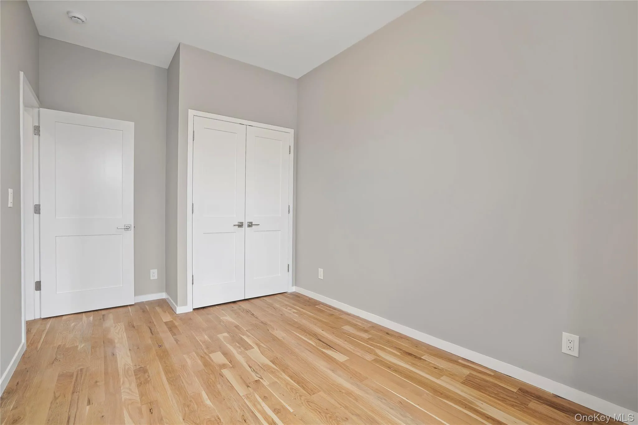 Unfurnished bedroom featuring a closet and light wood-style flooring Unfurnished bedroom featuring a closet and light wood-style flooring